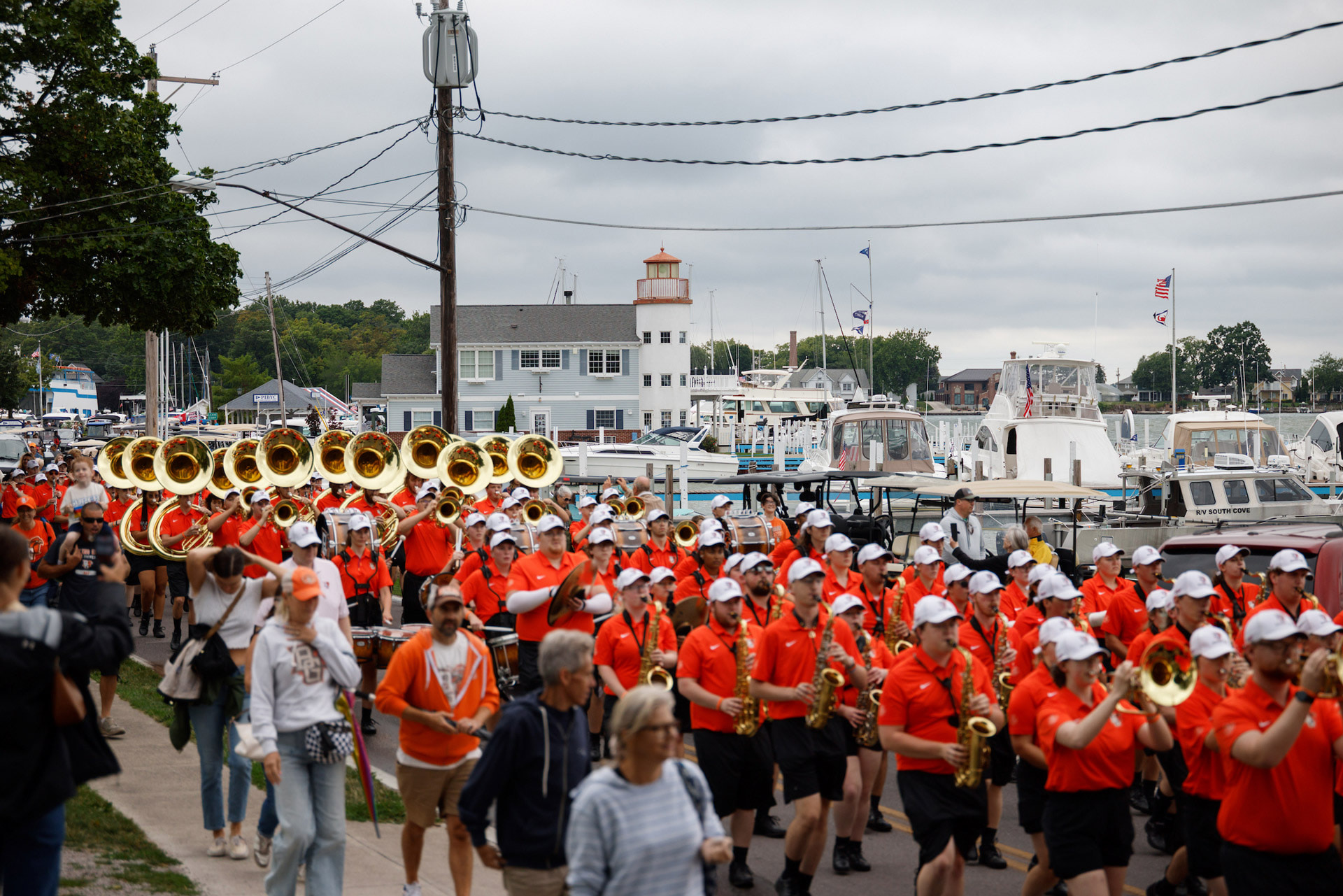Members of the BGSU Falcon Marching Band march in a parade.