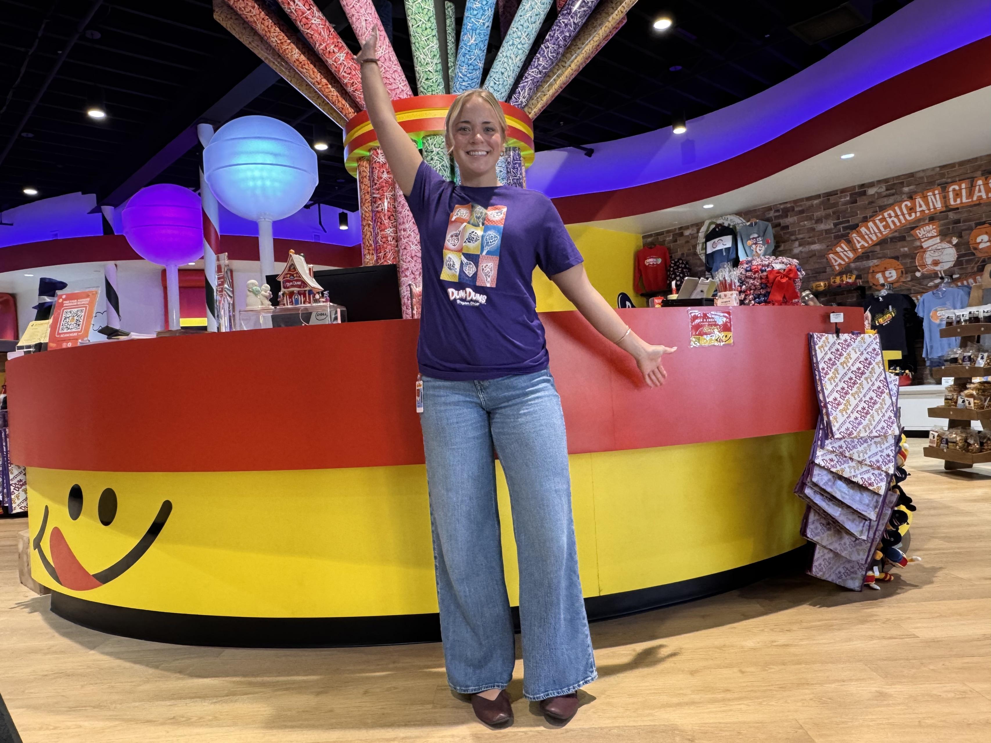 A person poses for a picture inside a candy store