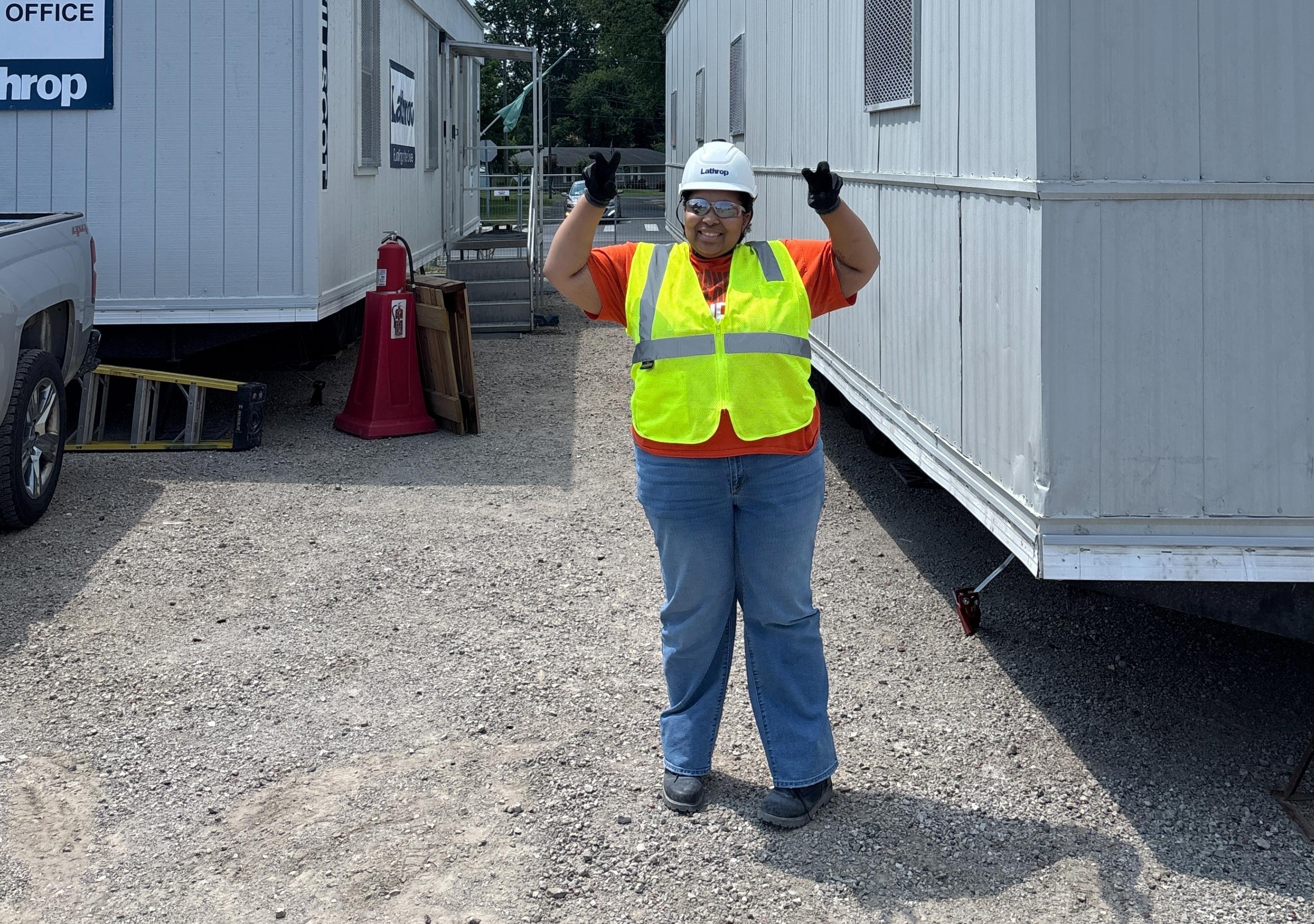 A person wearing a safety vest on a construction site