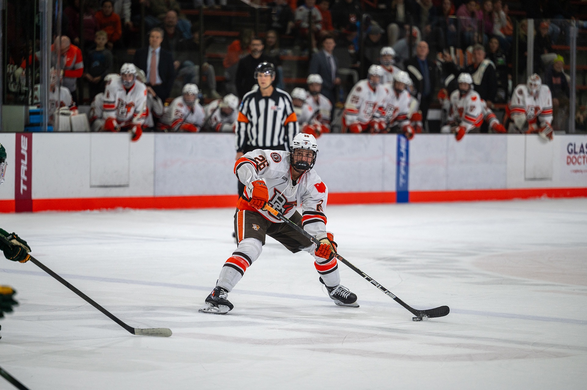 A hockey player takes a shot.