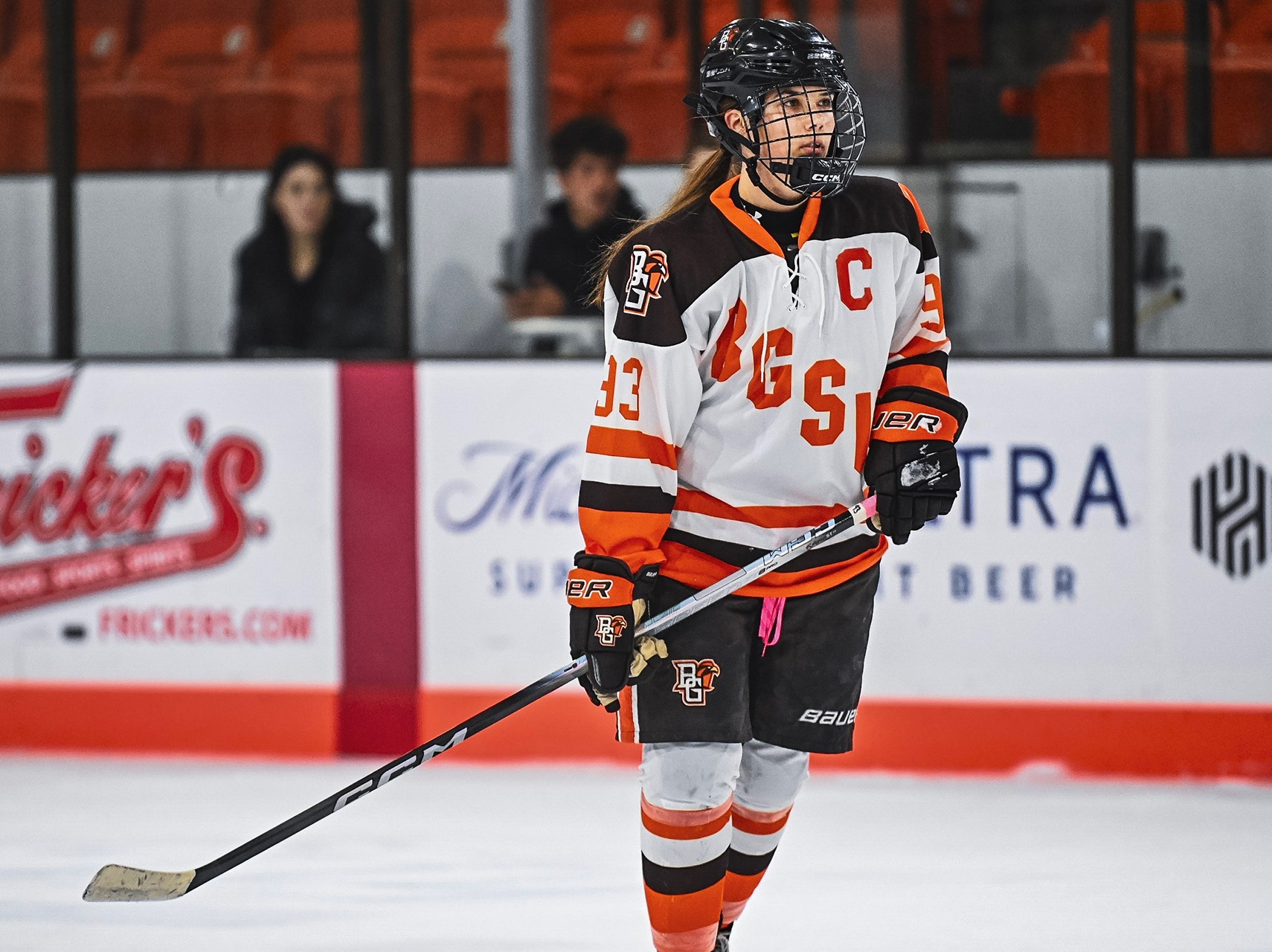 A hockey player stands on the ice.