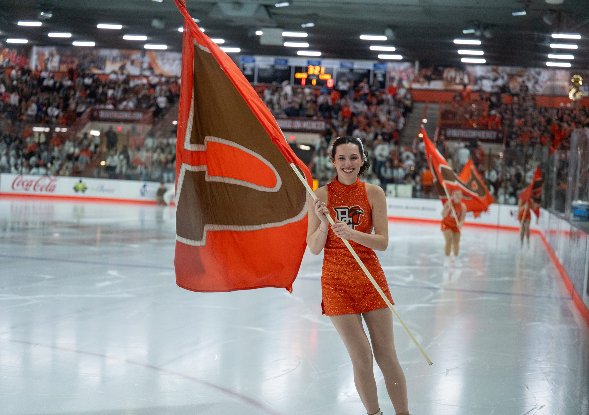A skater holds a flag.