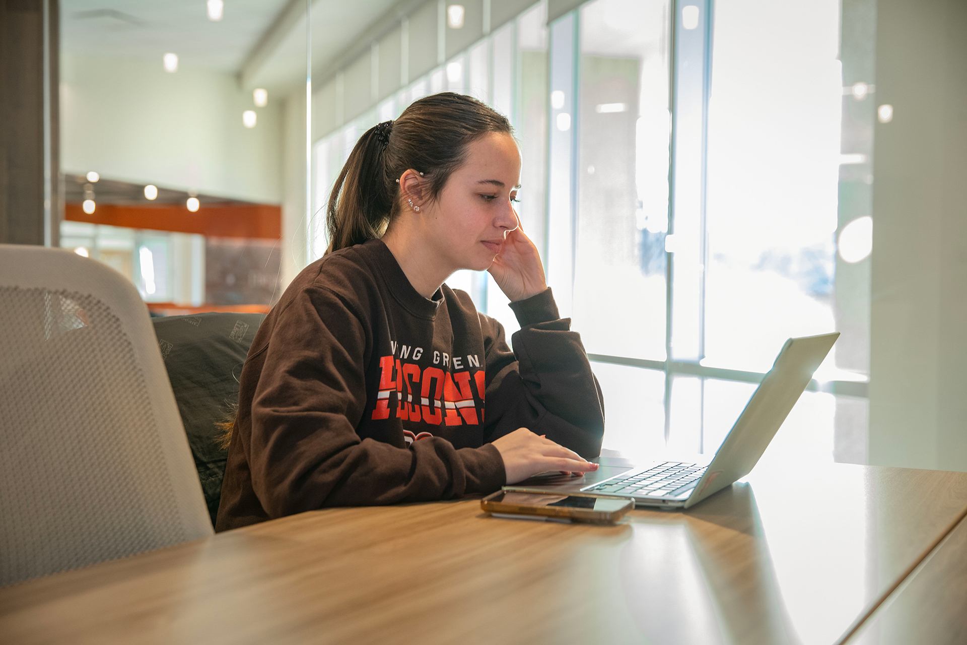 A BGSU student works on a laptop.