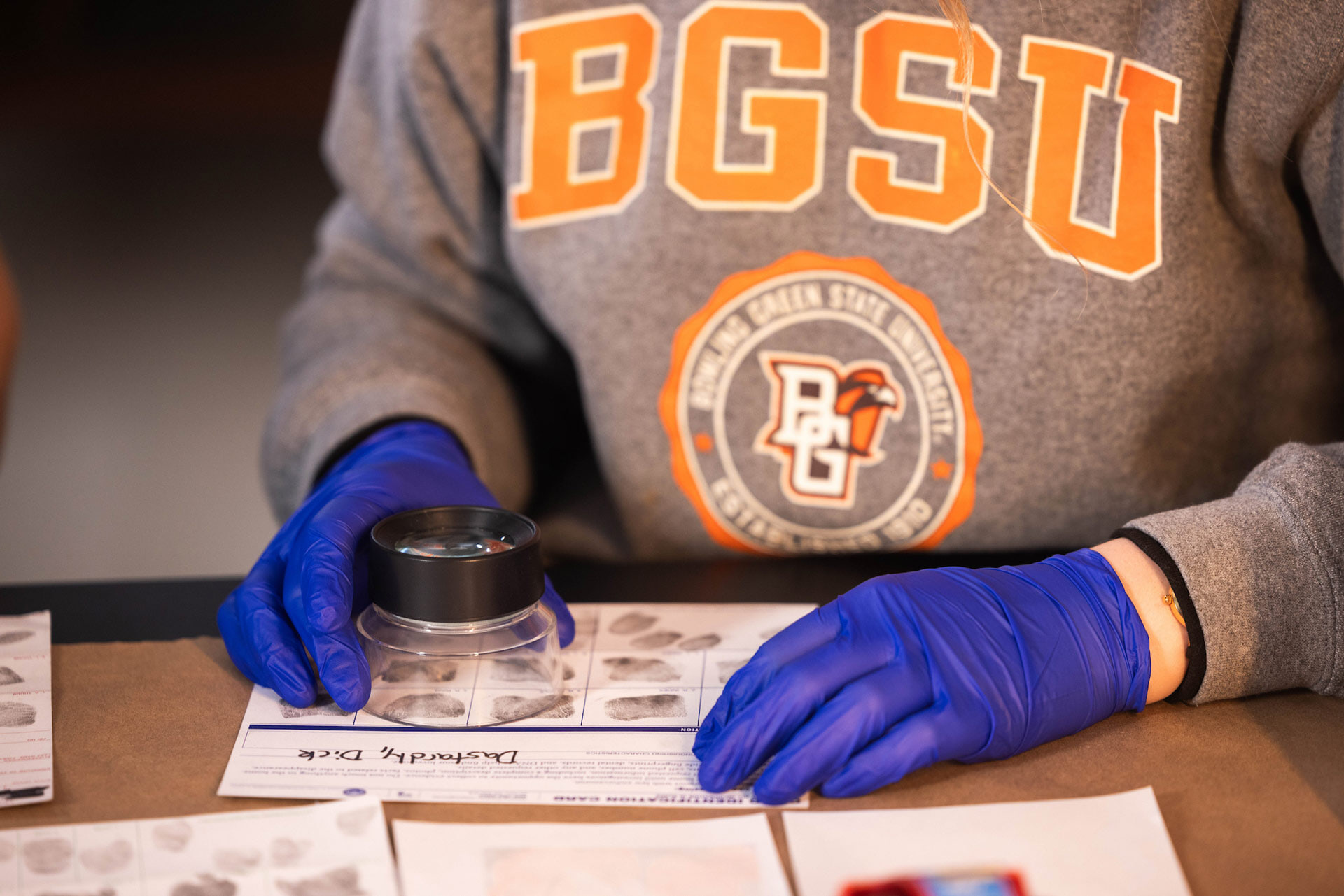 A forensic scientist examines fingerprints.