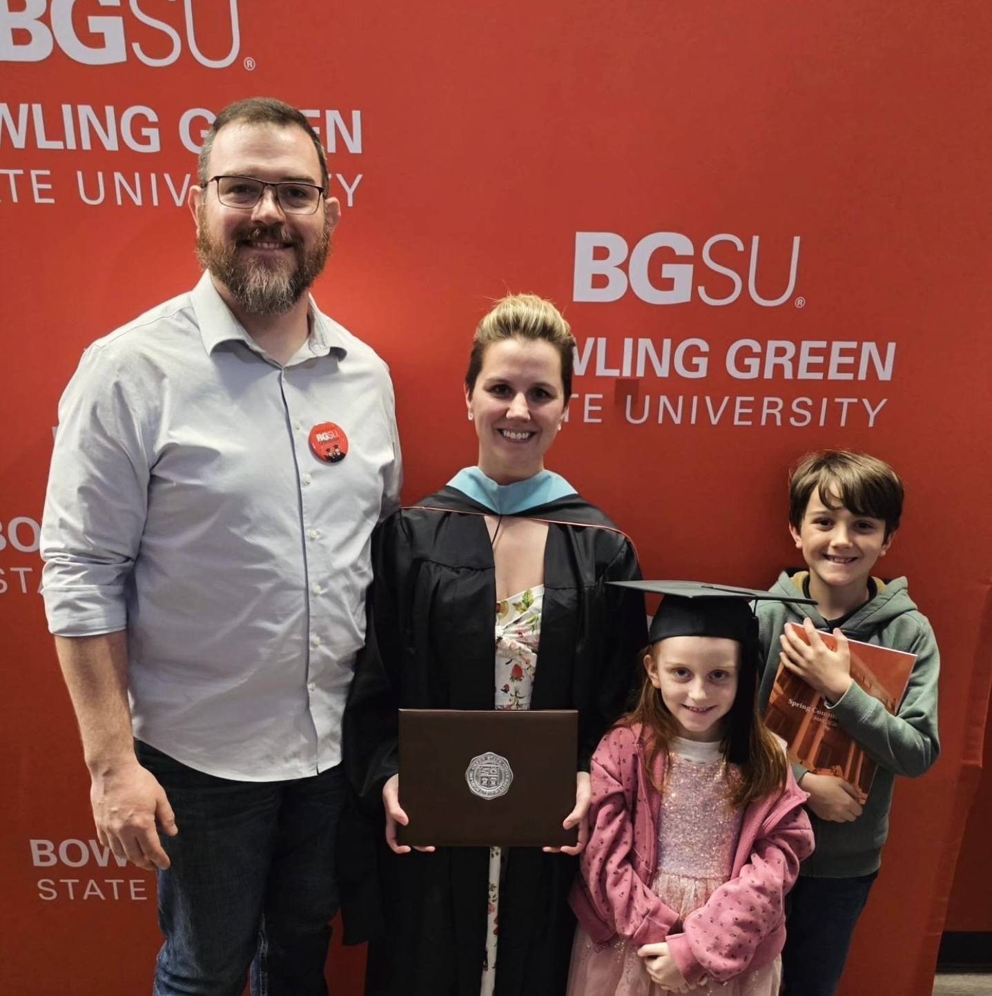 Four people pose for a photo during BGSU graduation