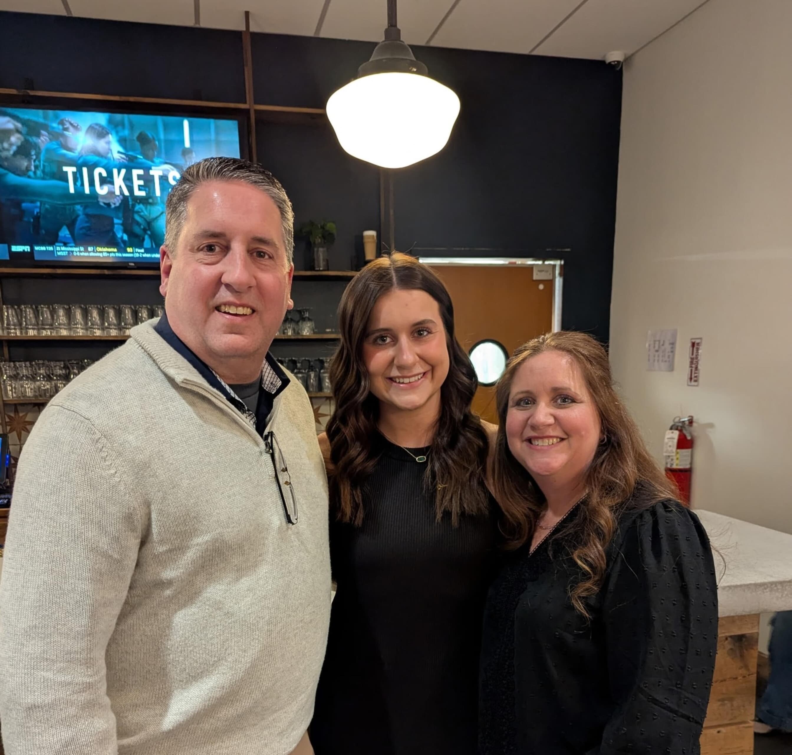 Three people pose for a photo