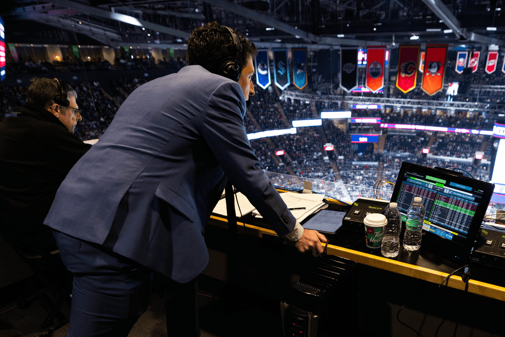 An announcer takes notes.