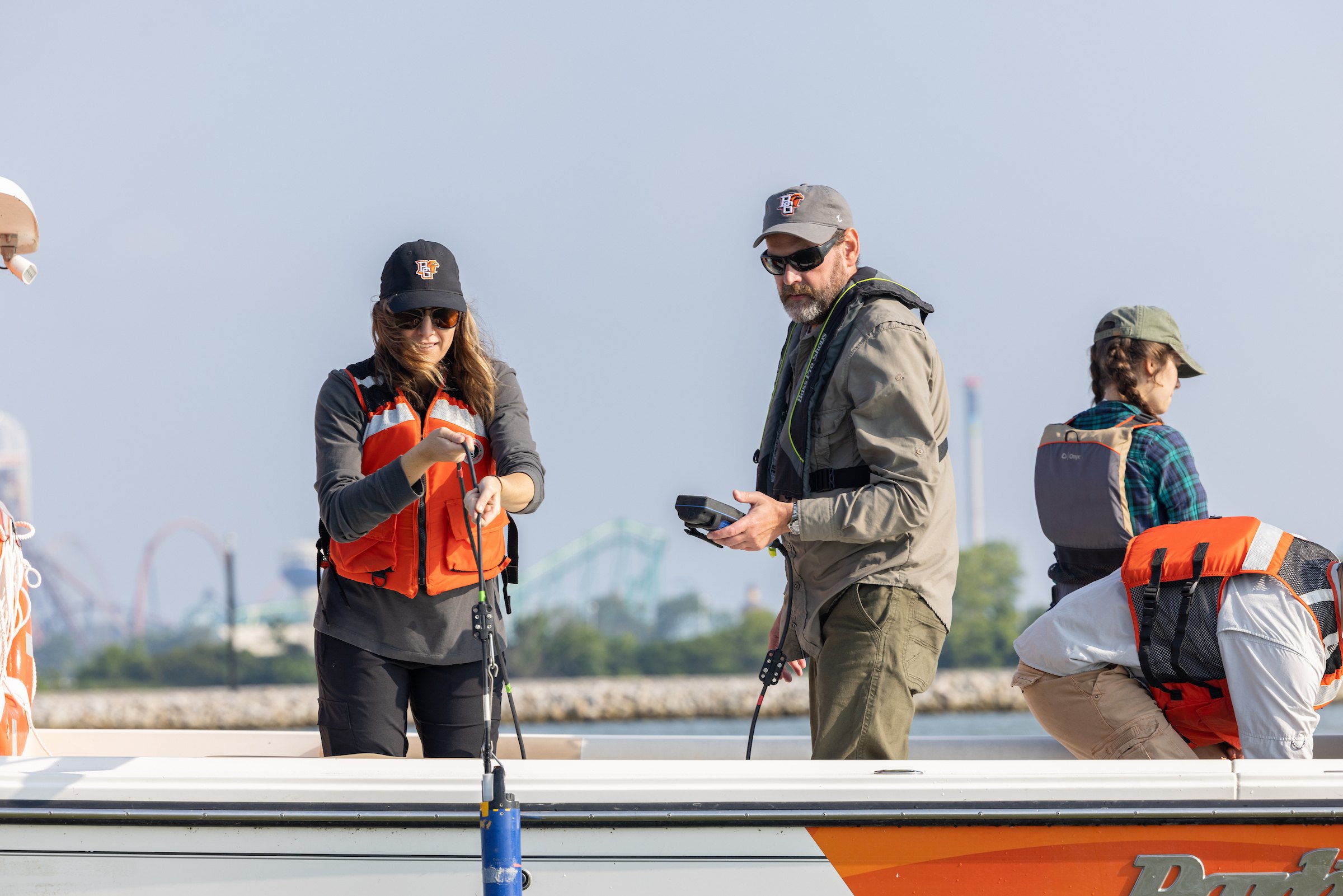 Two scientists take samples on a lake.