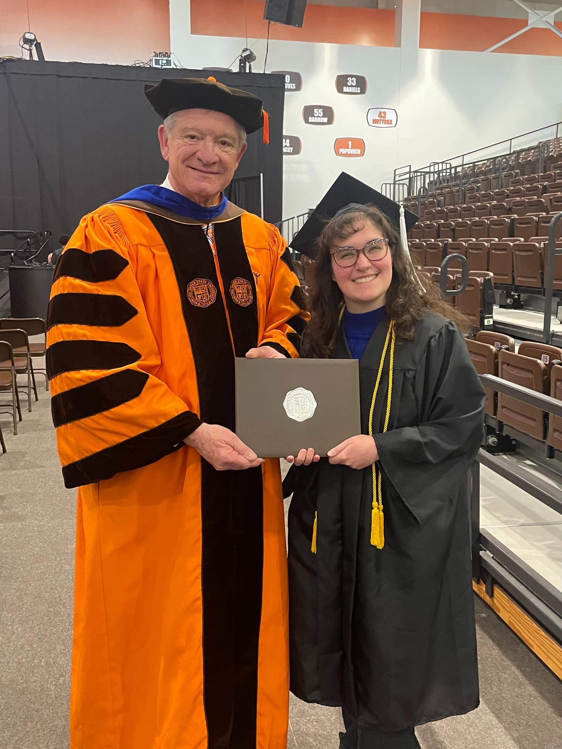 Ruby Michalec poses with BGSU President Rodney K. Rogers during commencement ceremonies in April 2026.