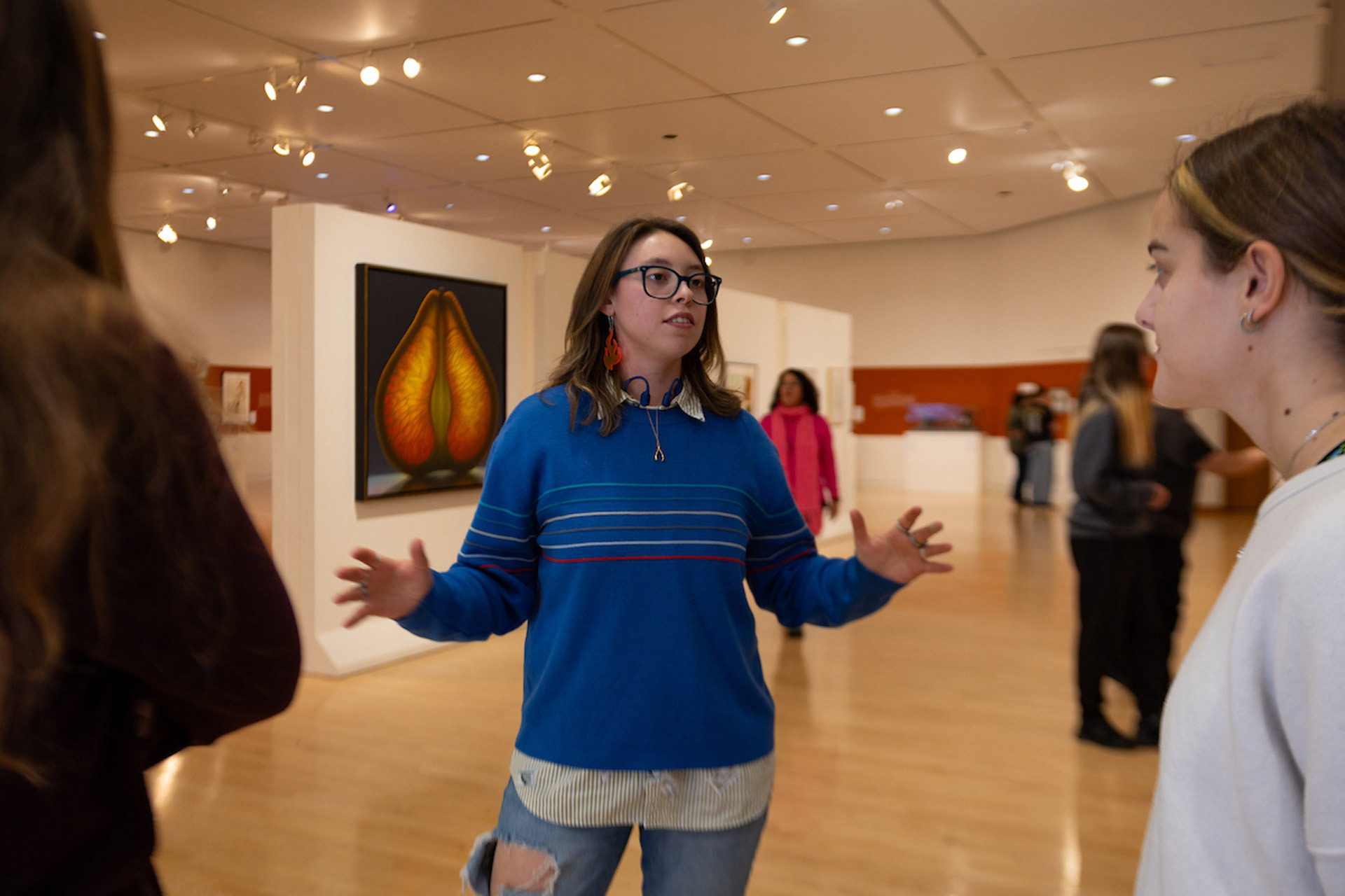 A person provides a tour of the exhibition.