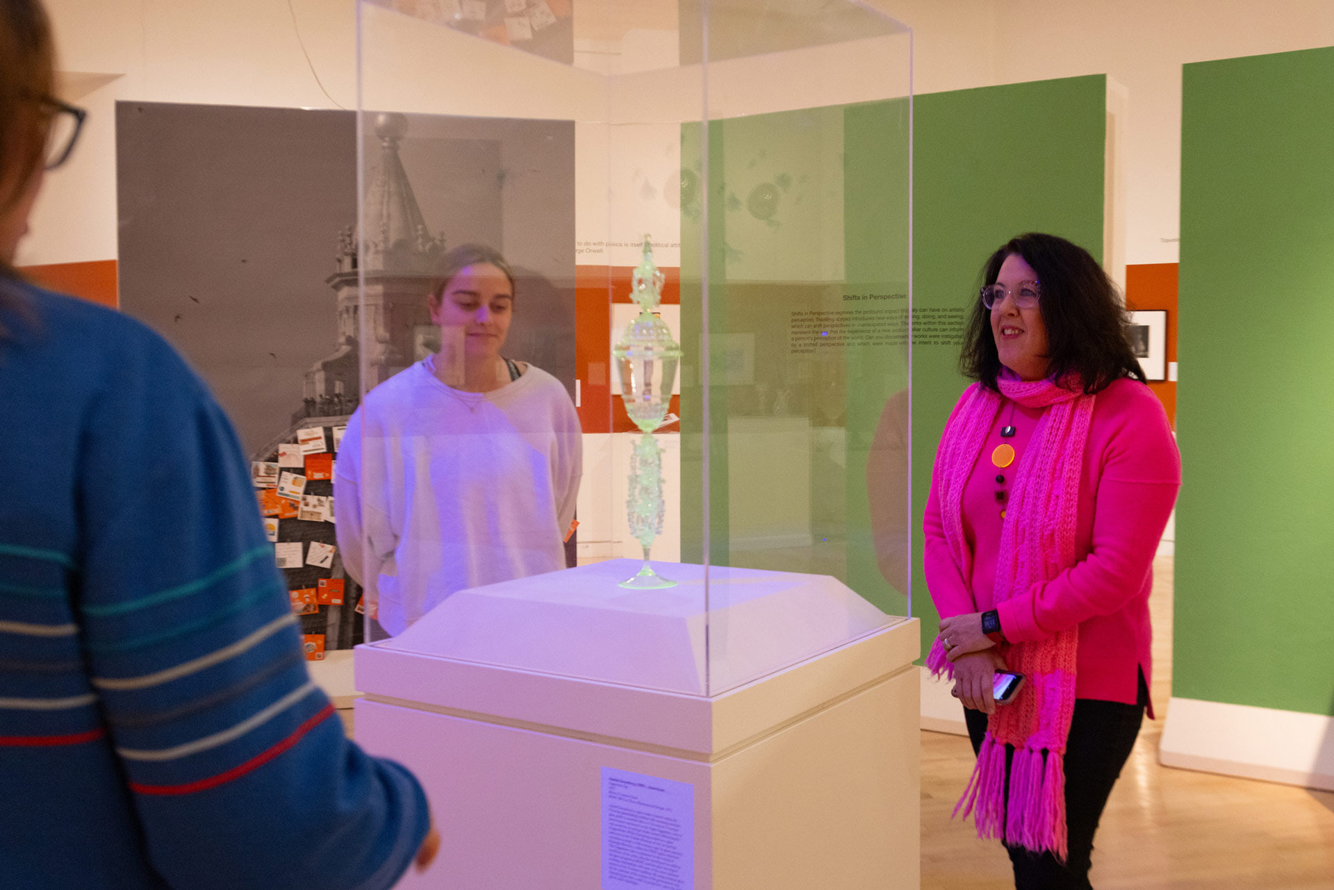 Dr. Terry-Fritsch stands next to an encased exhibit.