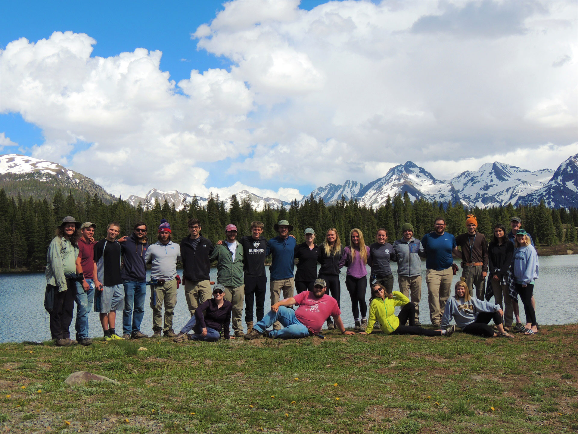 Students pose for a photo with the Rocky Mountains in the background.