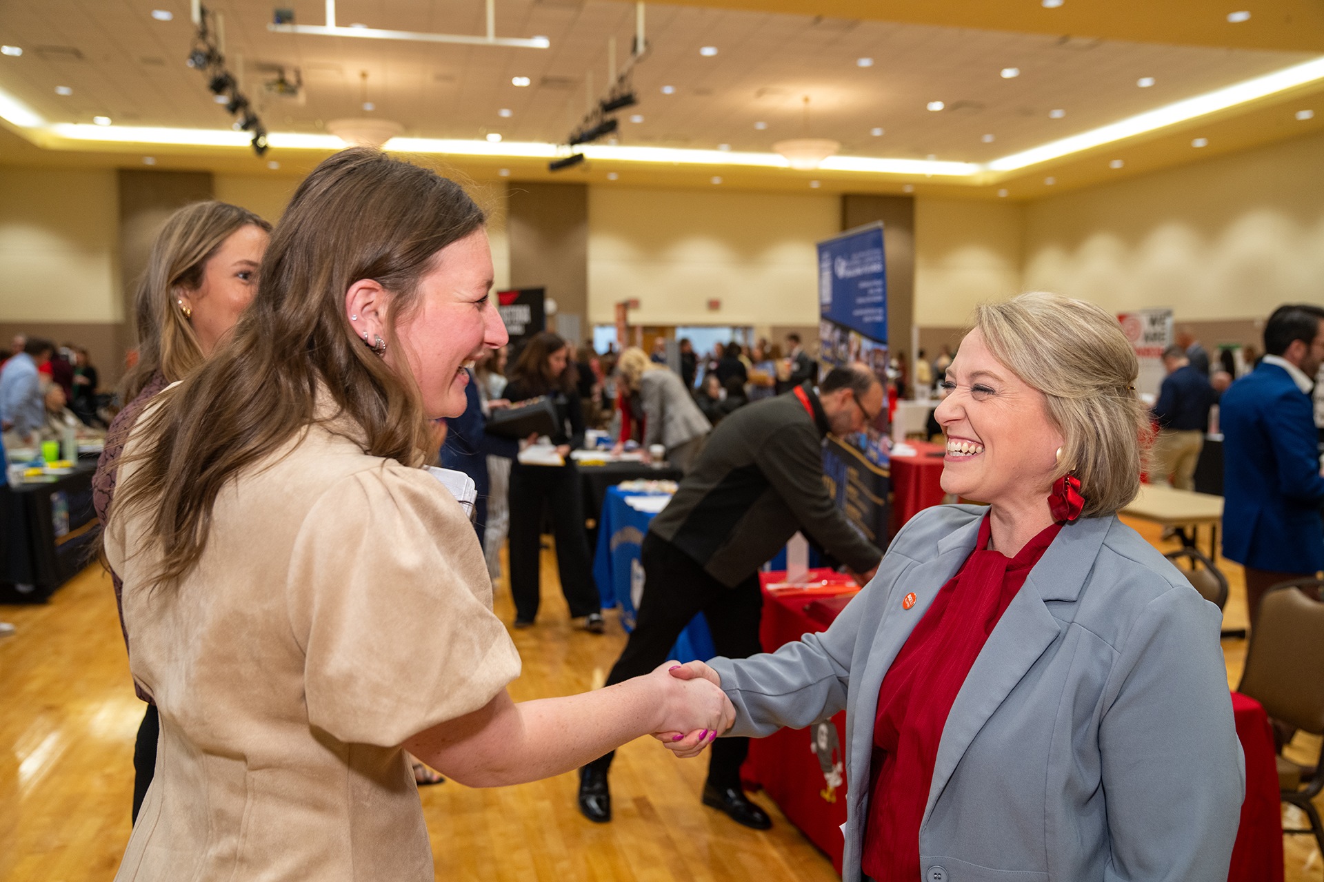  A BGSU education student shakes hands with a school district representative