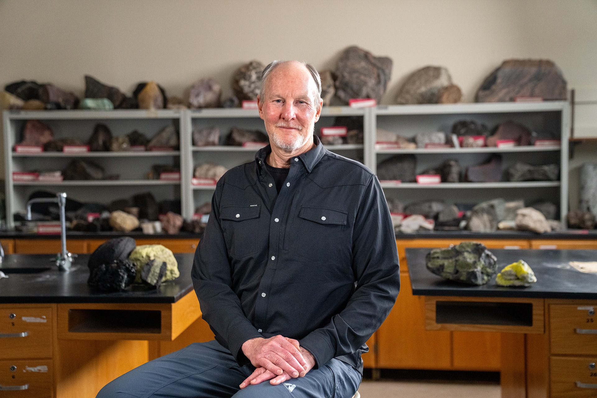A professor poses for a photo in a lab.