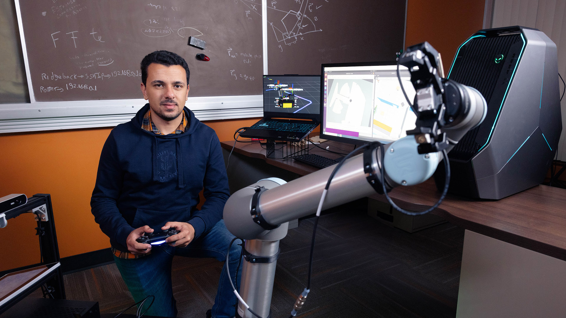A BGSU student controls a robot