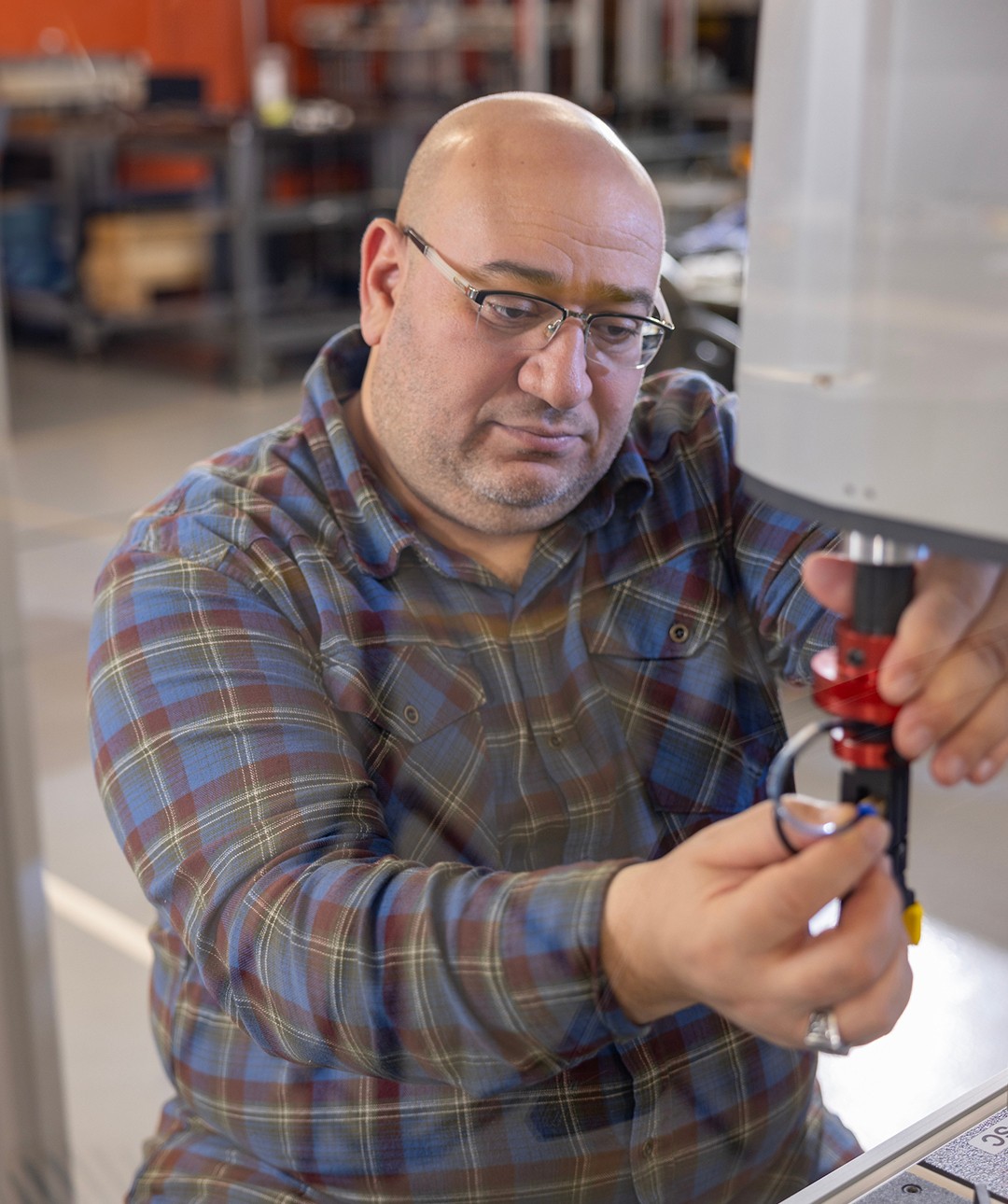 A professor works in a robotics lab at BGSU