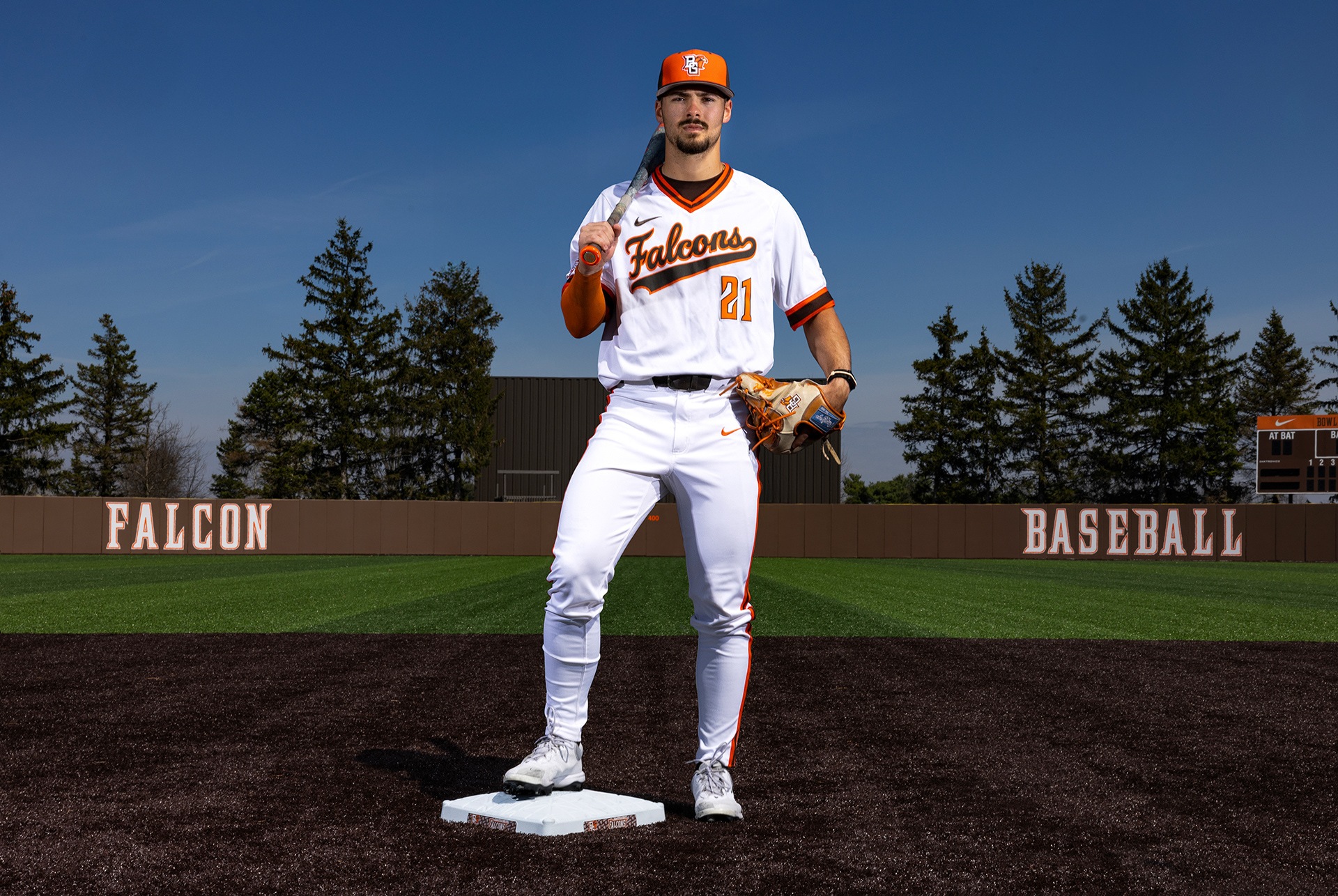 A baseball player poses for a photo at second base.