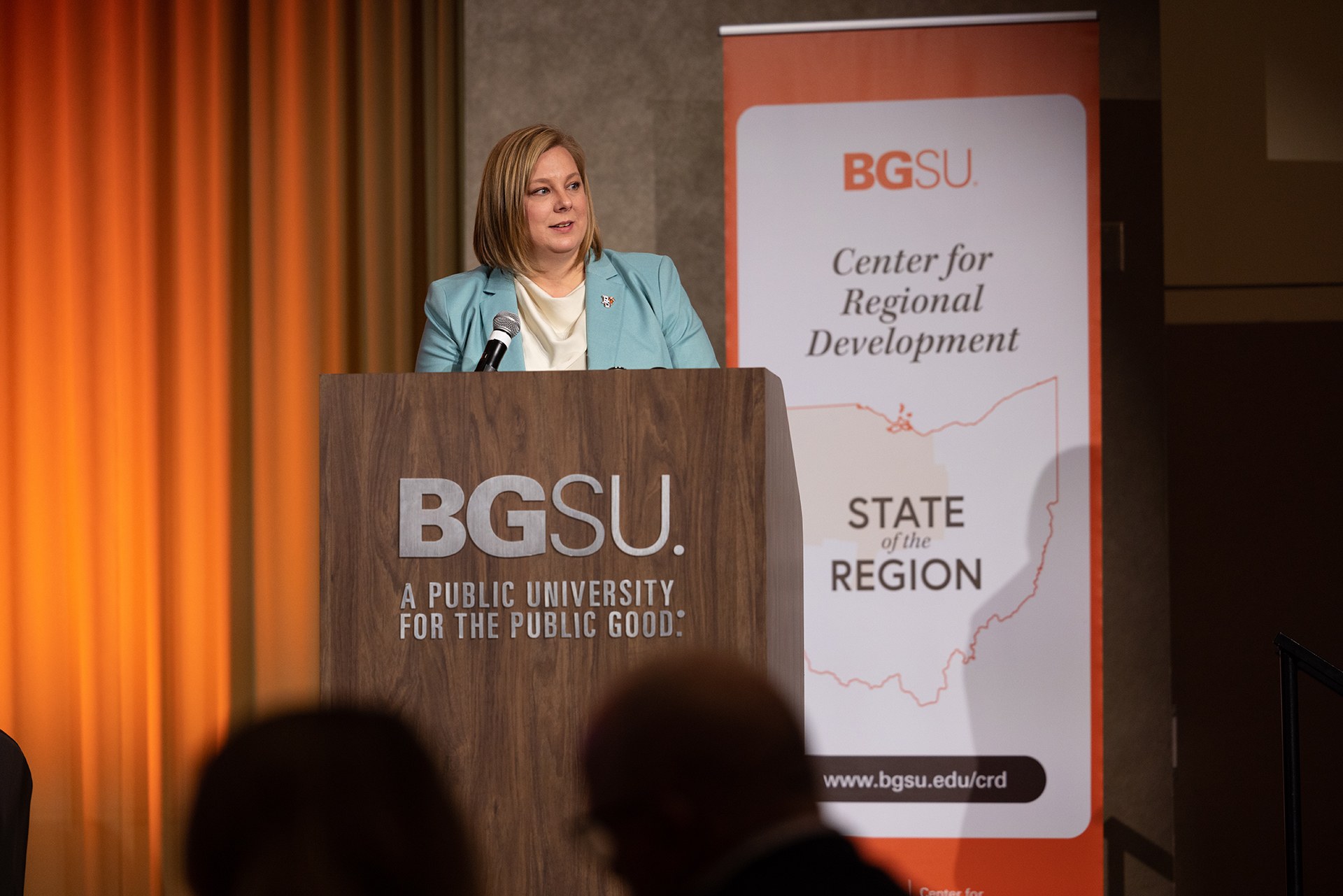 A person speaks at a podium.