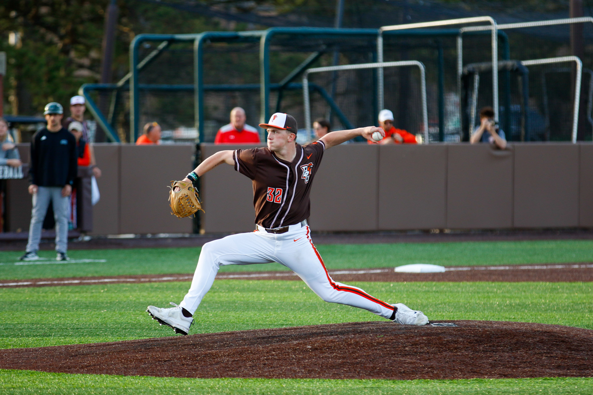A pitcher delivers to home plate. 
