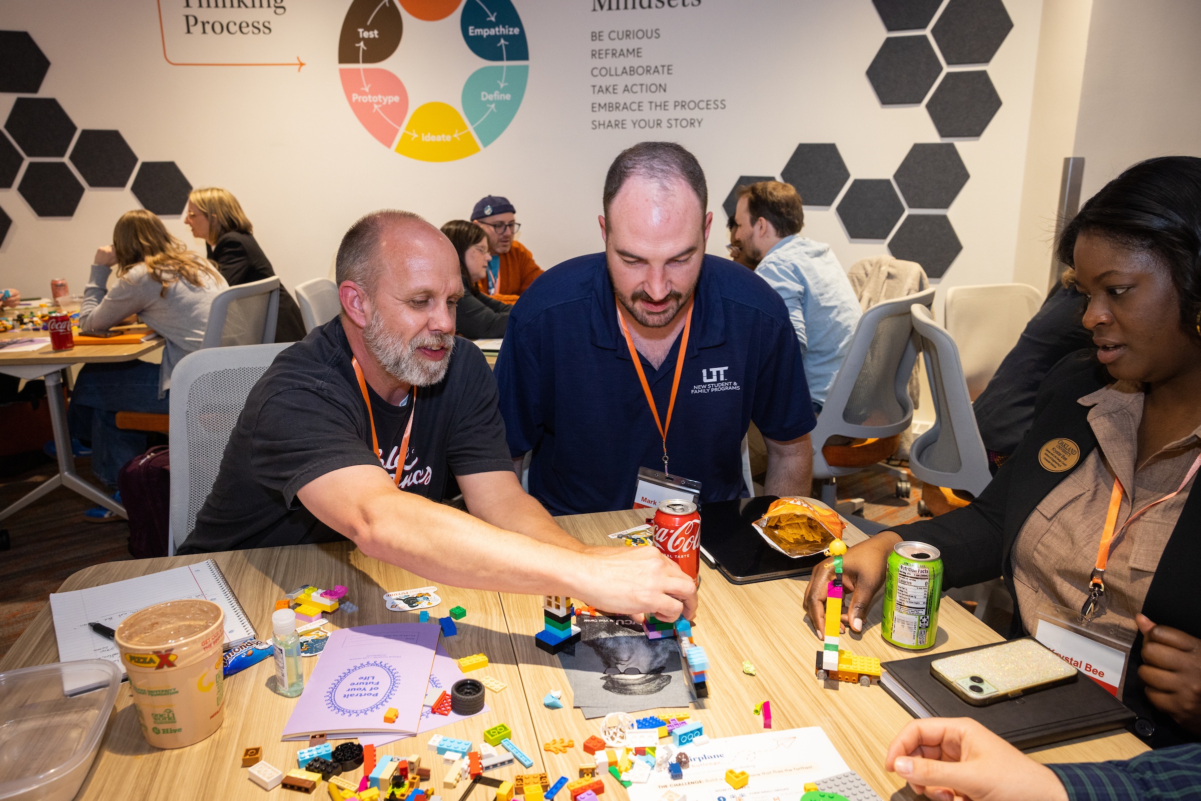 Two people solve a challenge using Legos.