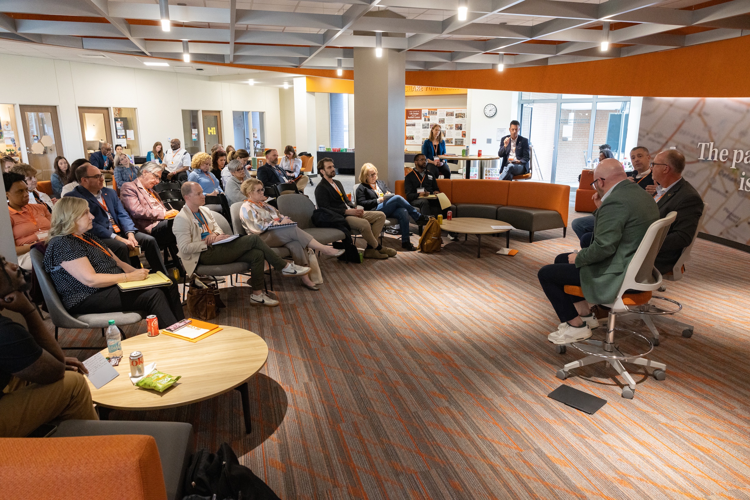 Several people present to a room of people 