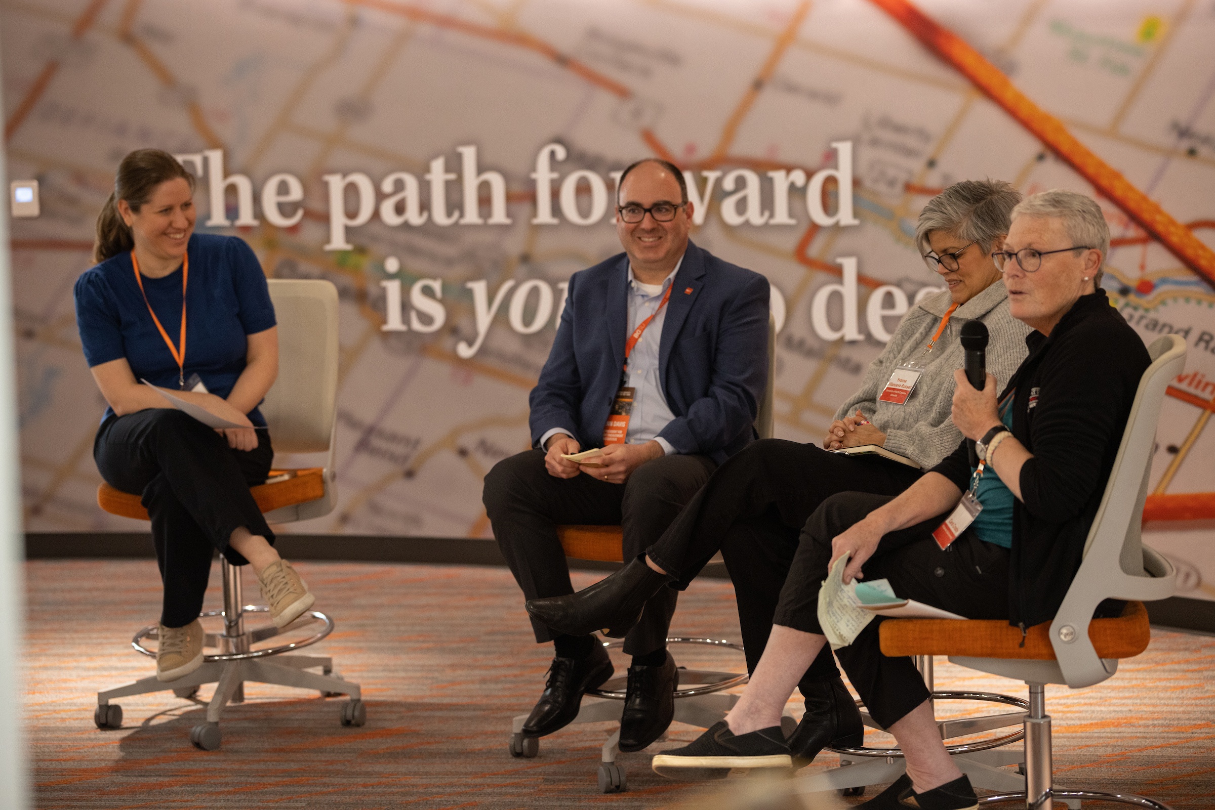 Four people present at the front of a room