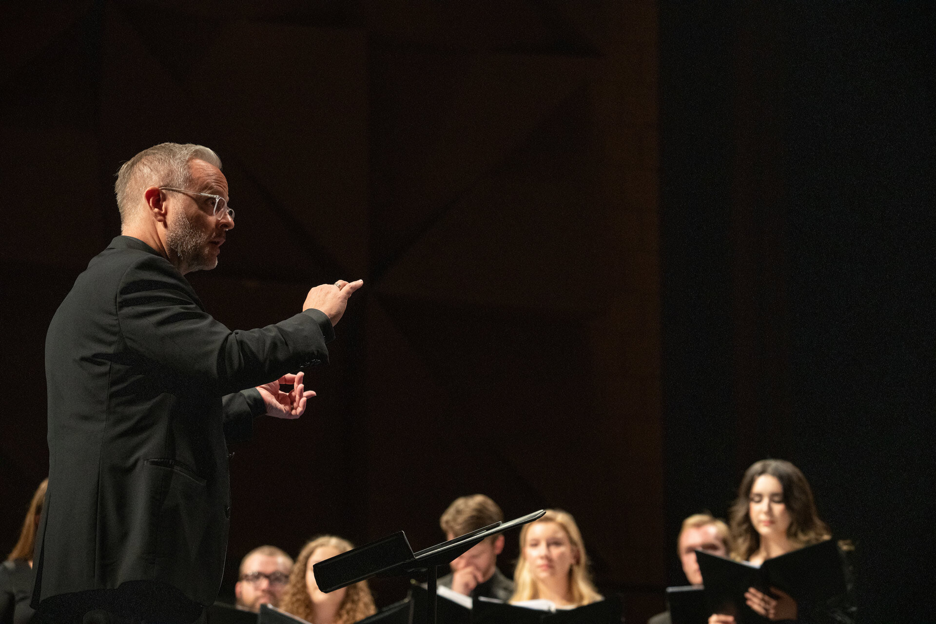A conductor directs a choir.