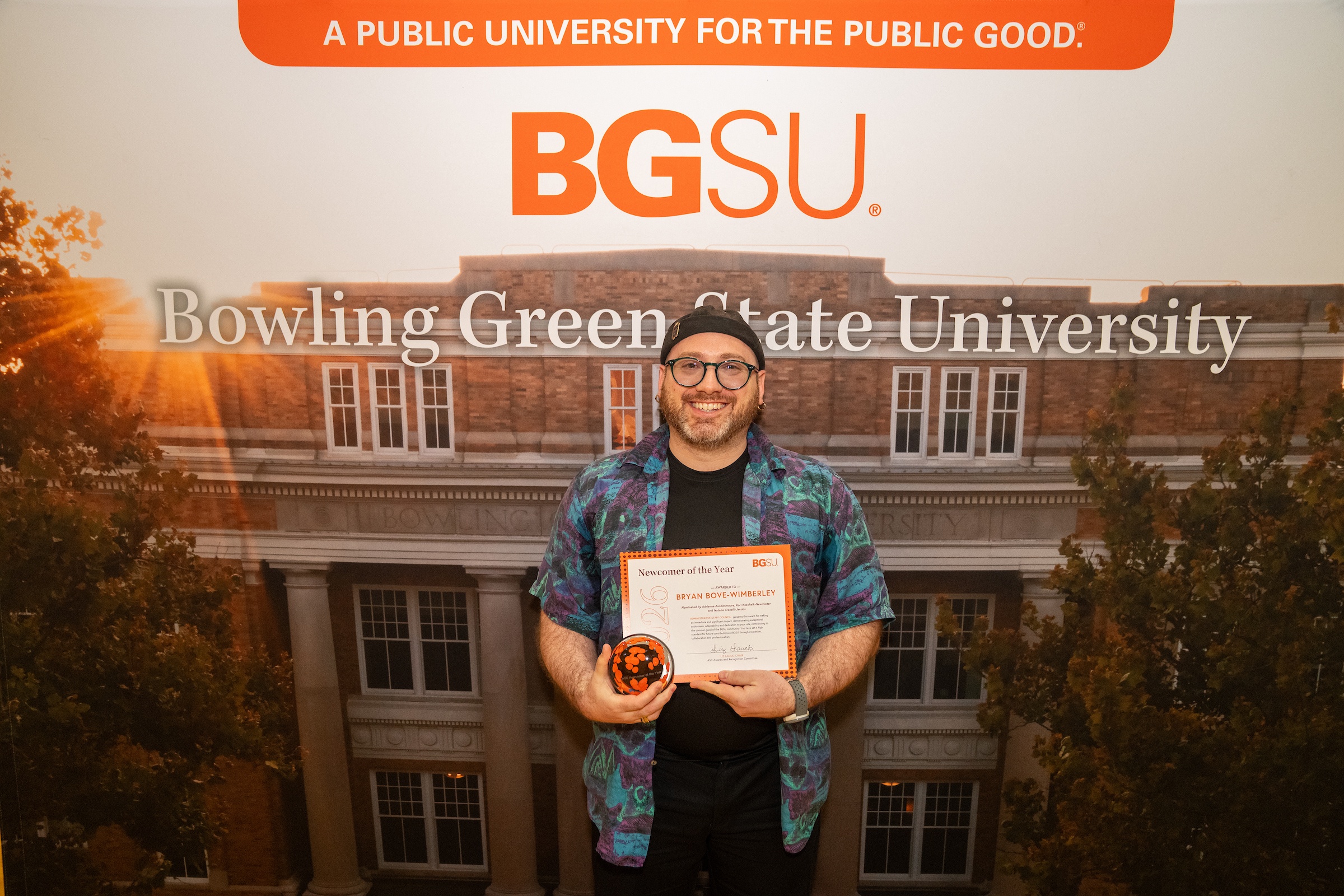 A person holds an award certificate
