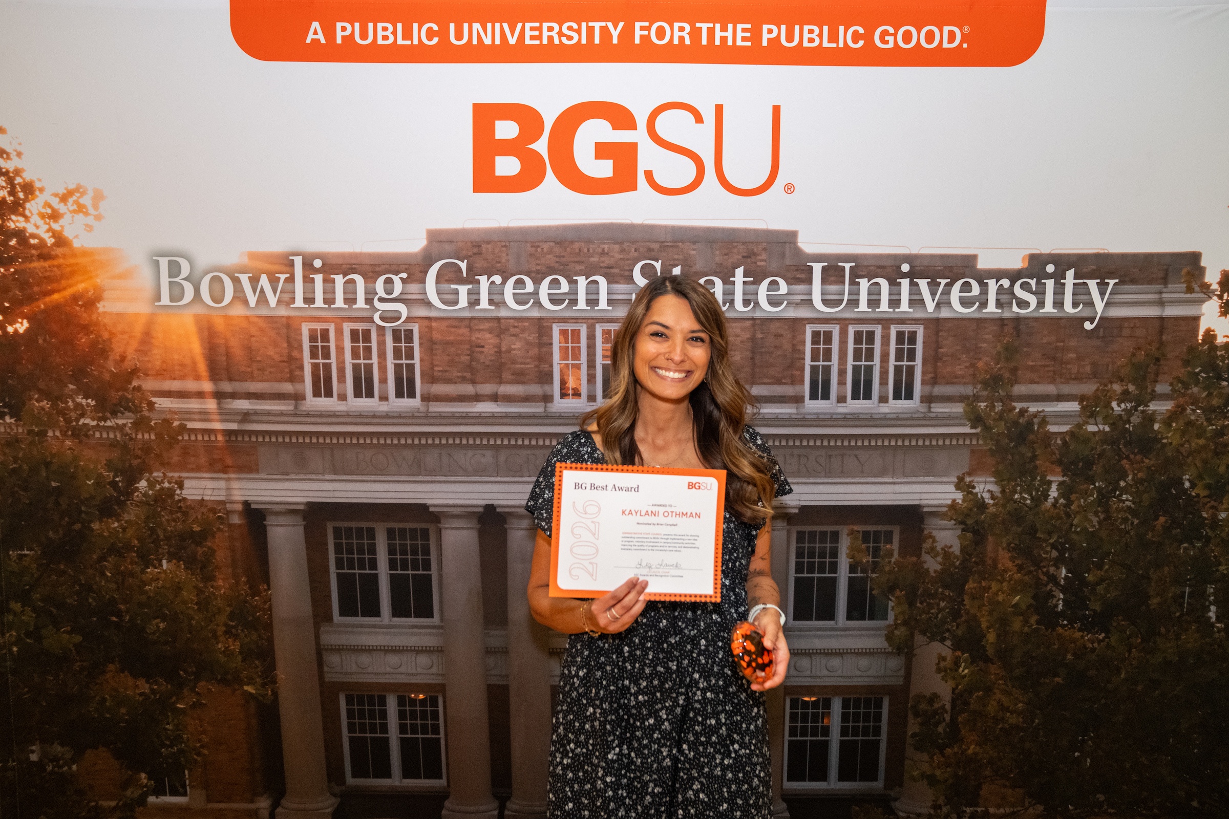 A person holds an award certificate