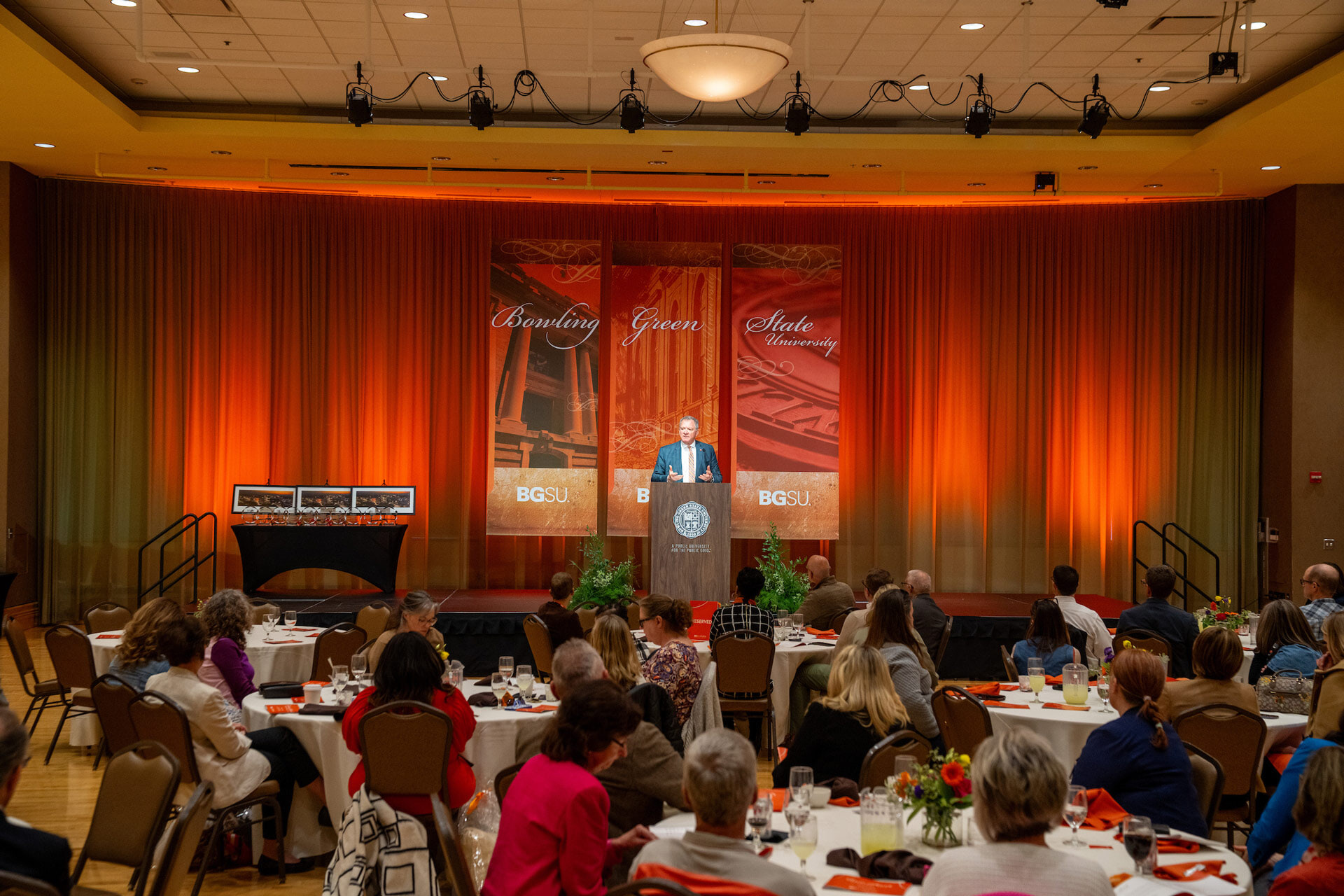 People seated at tables in a ballroom during an awards ceremony