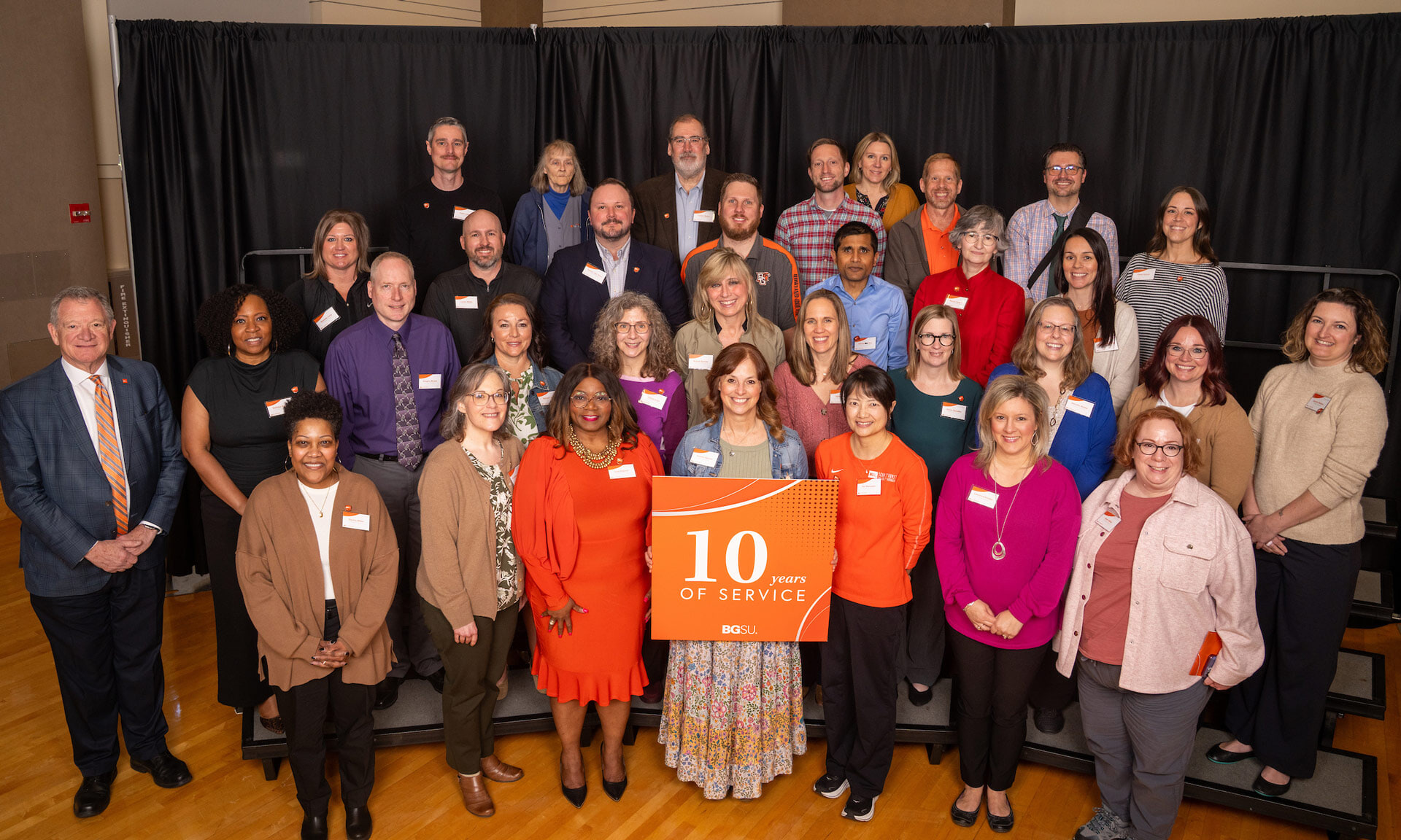  BGSU employees hold a sign with text that reads: 10 years of service