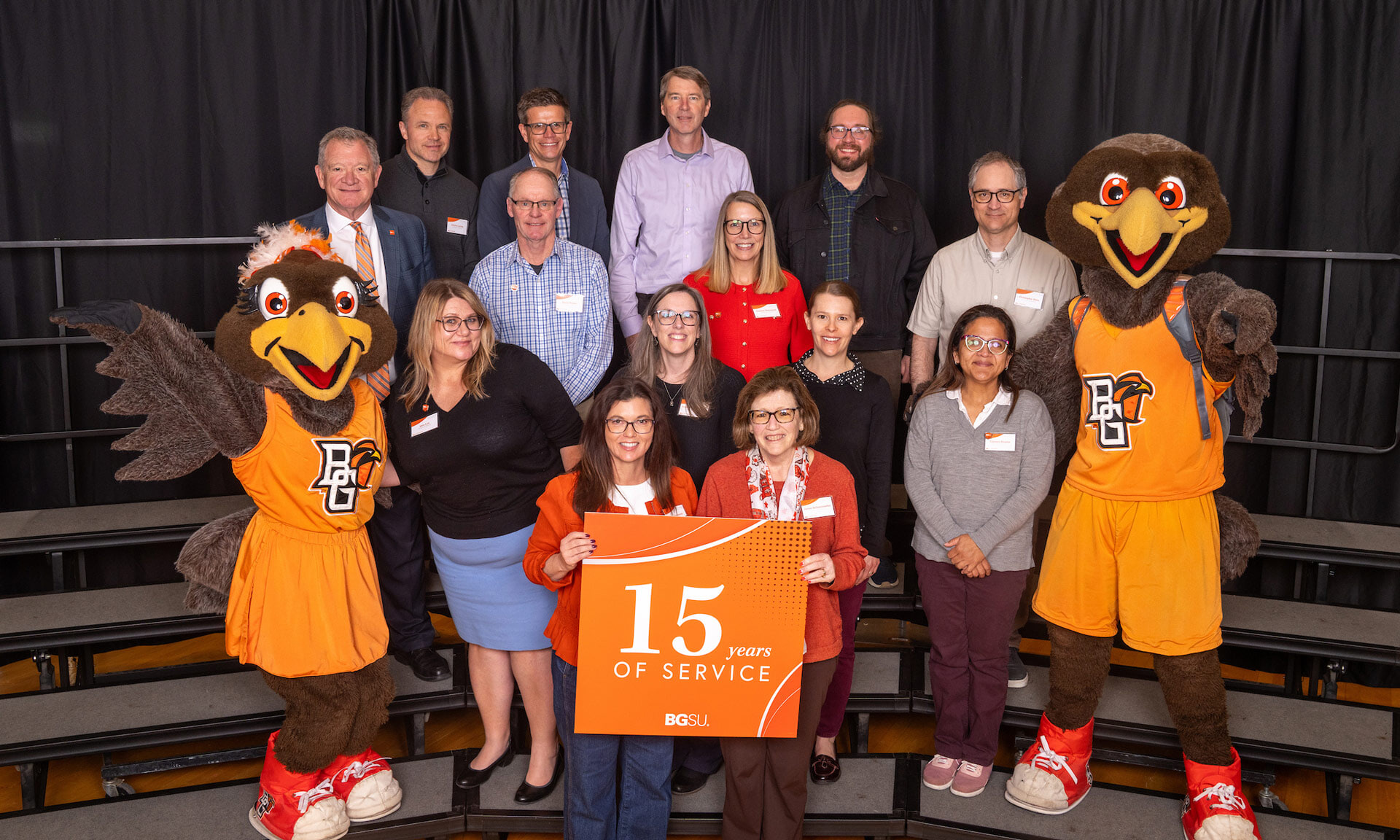 BGSU employees hold a sign with text that reads: 15 years of service