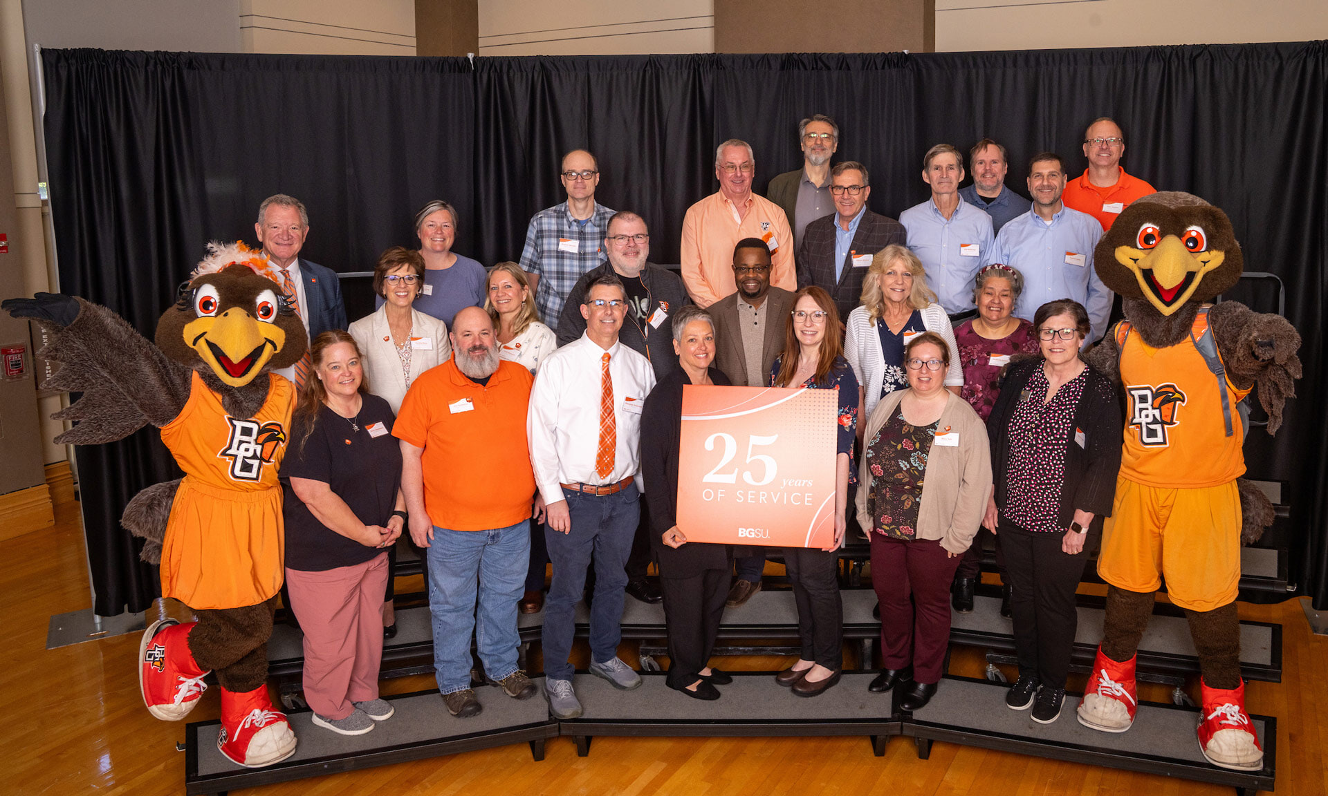 BGSU employees hold a sign with text that reads: 25 years of service