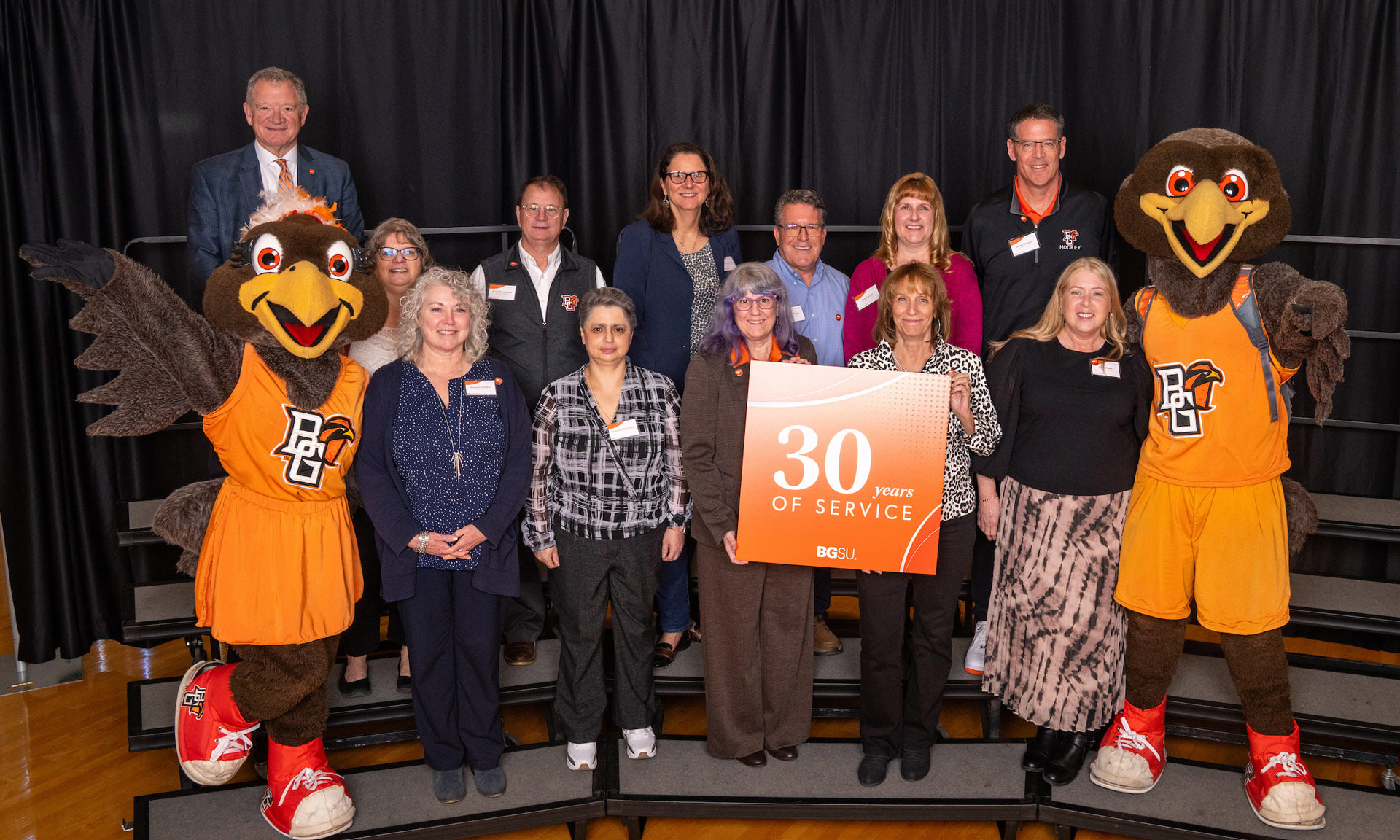 BGSU employees hold a sign with text that reads: 30 years of service