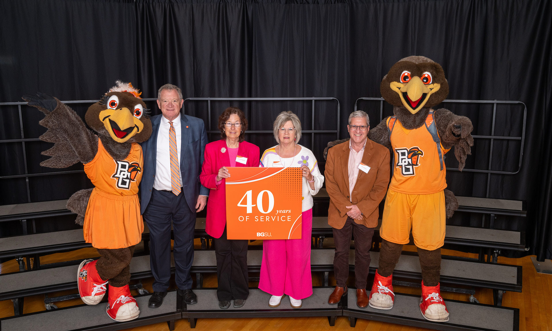 BGSU employees hold a sign with text that reads: 40 years of service
