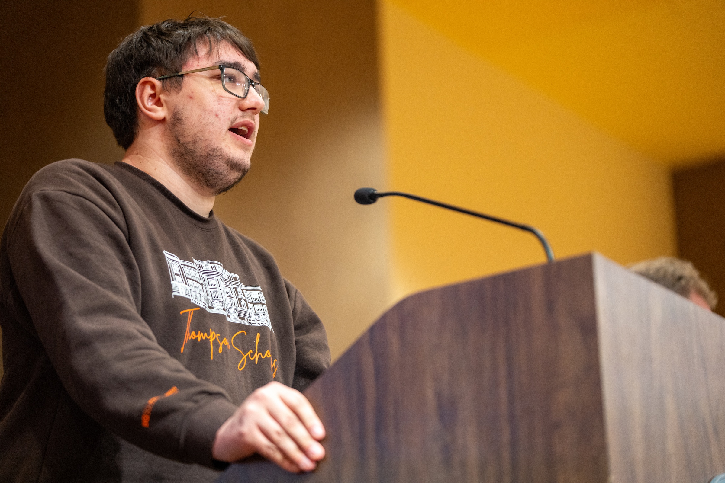 A person speaks at a podium.