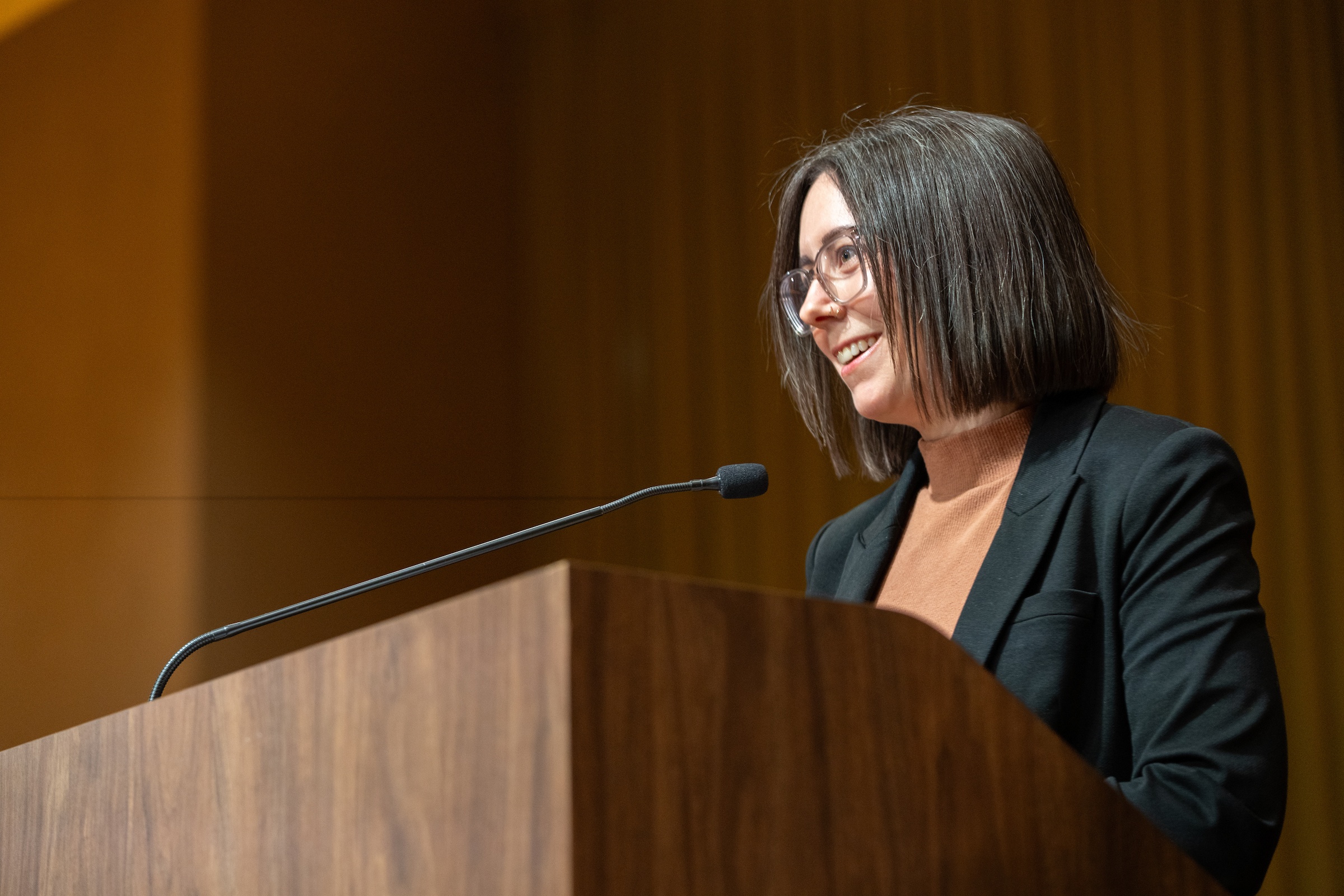A person speaks at a microphone