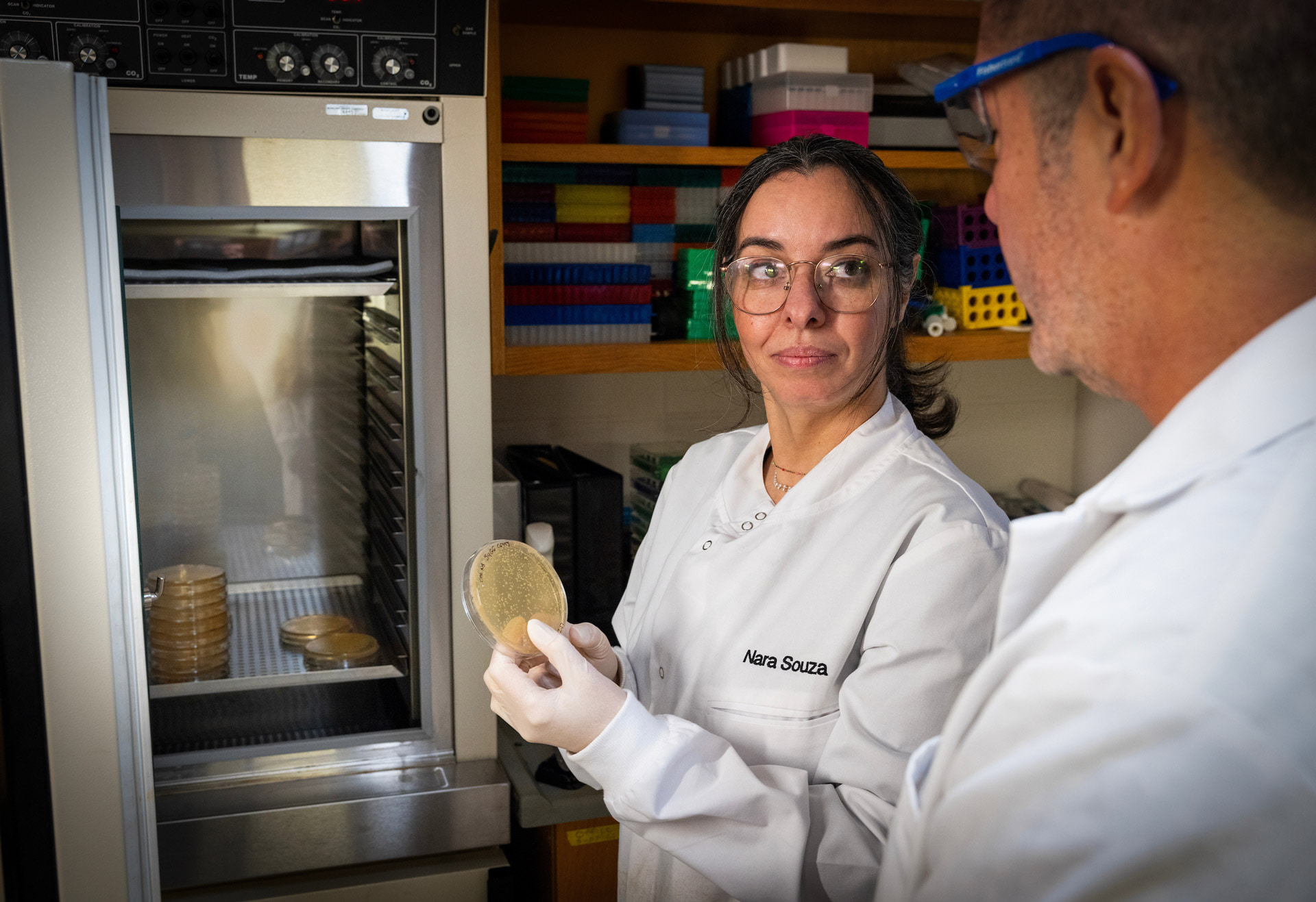 Two scientists examine a sample.