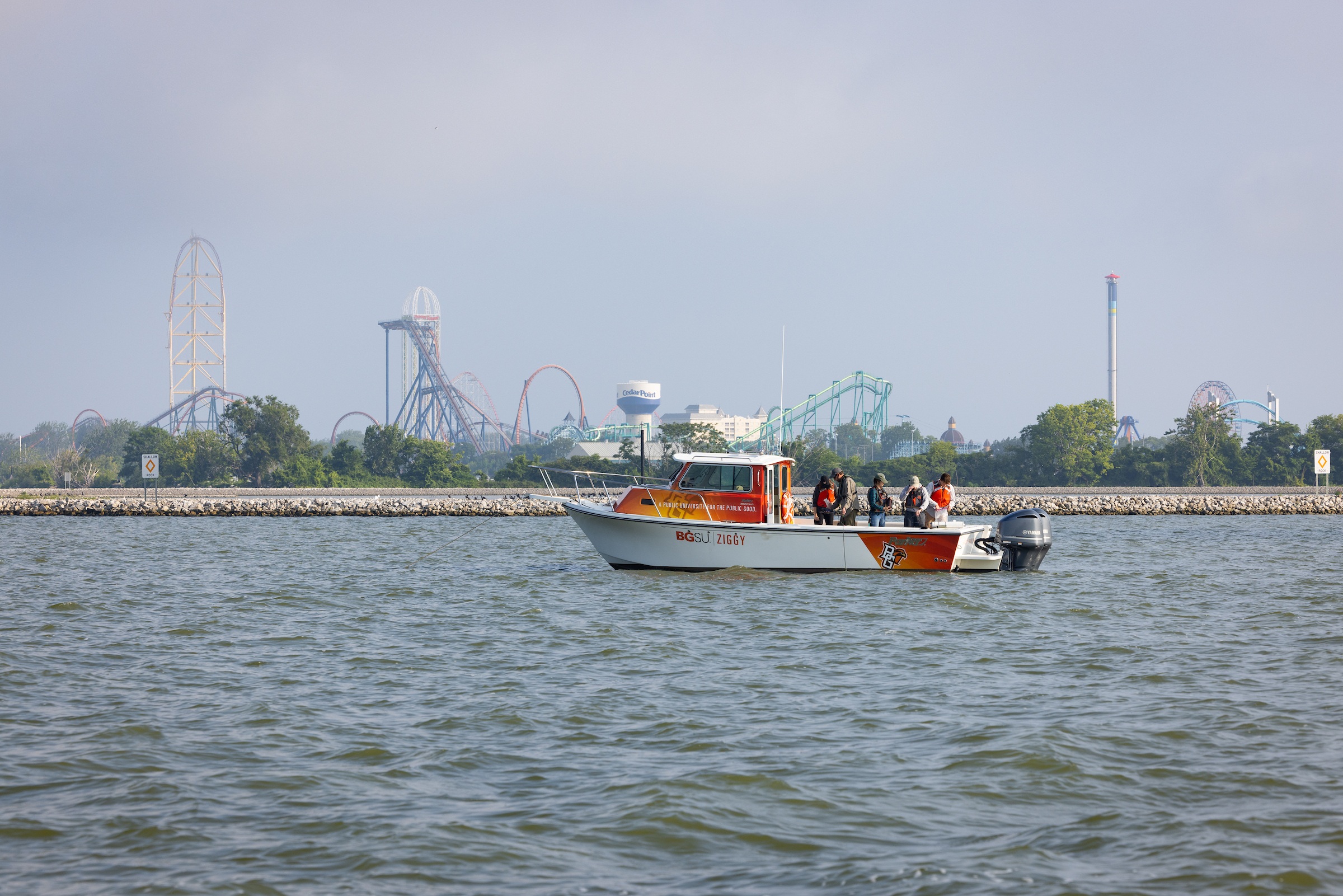 Researchers on a boat take water samples from Lake Erie