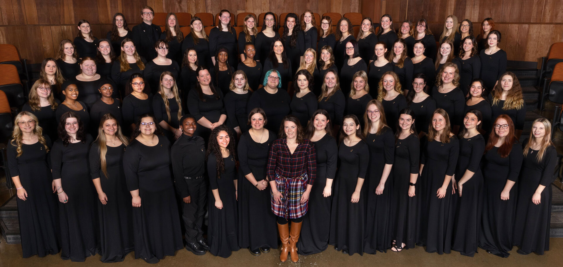 A women's chorus poses for a photo.