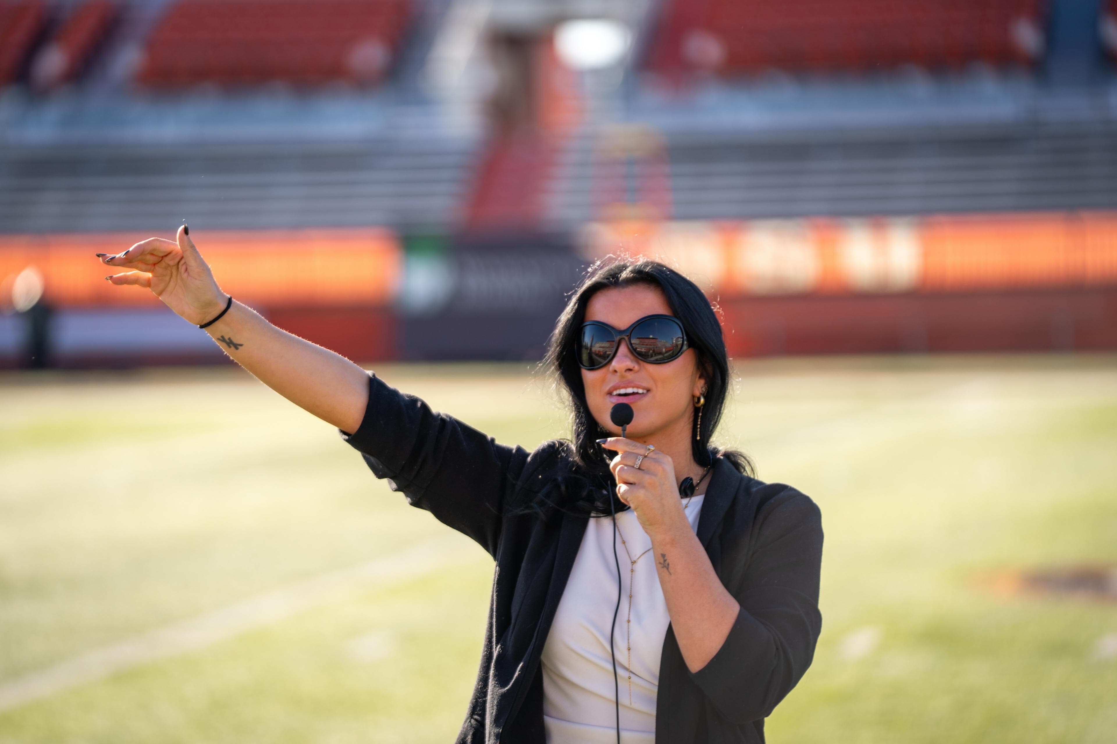 A person wearing sunglasses directs a music video