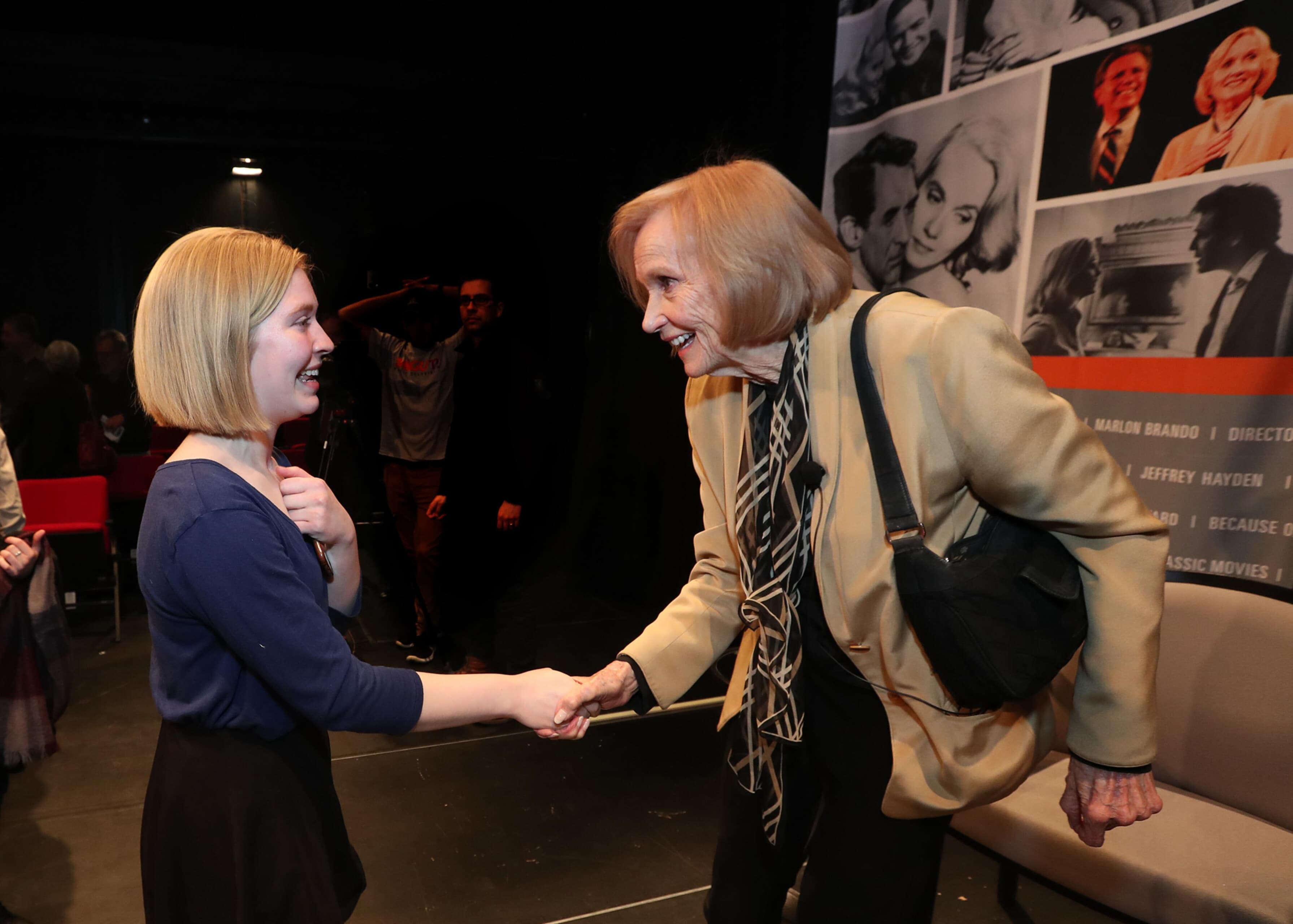 Eva Marie Saint shakes hands with a student