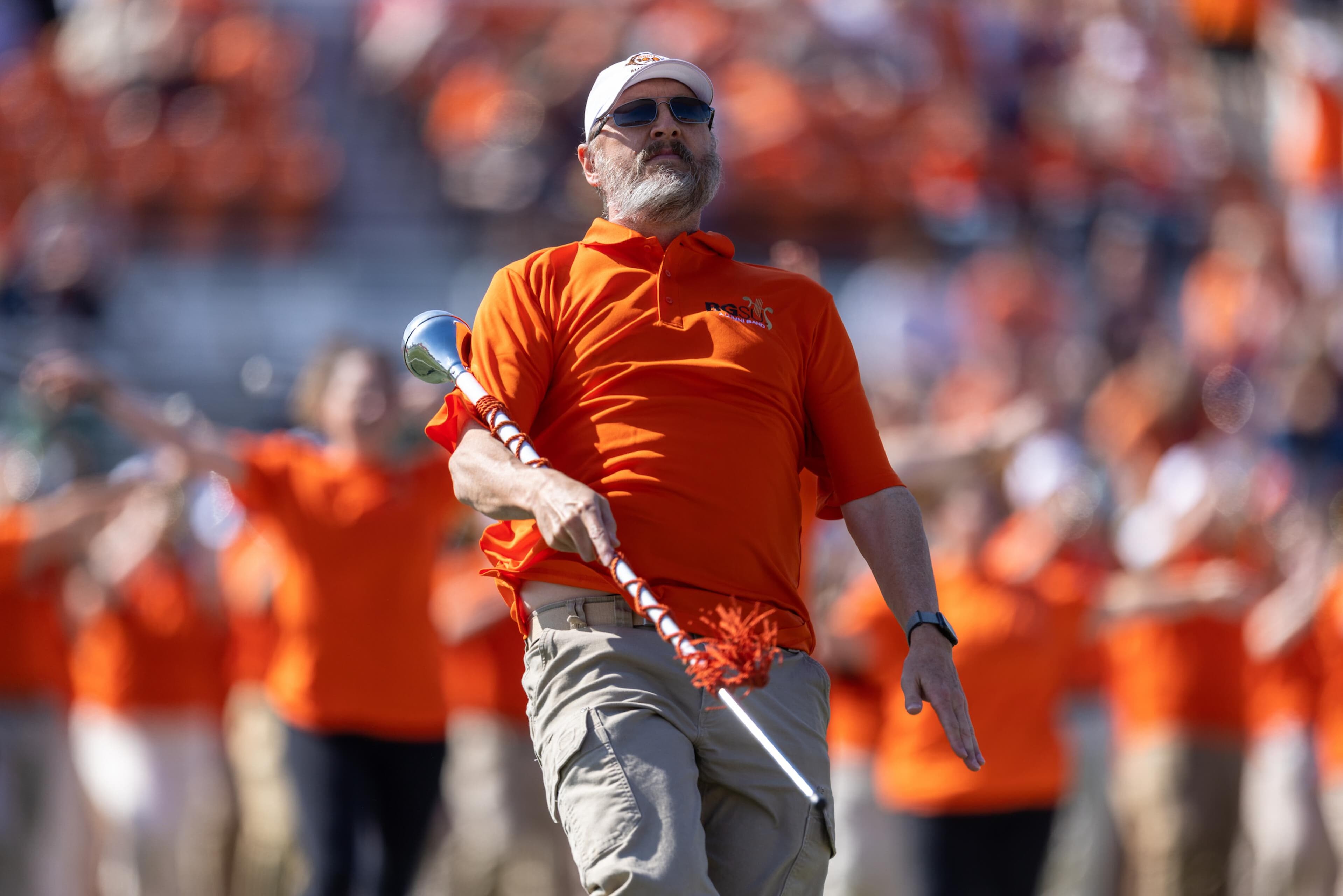 Alumni band member on the field during Homecoming