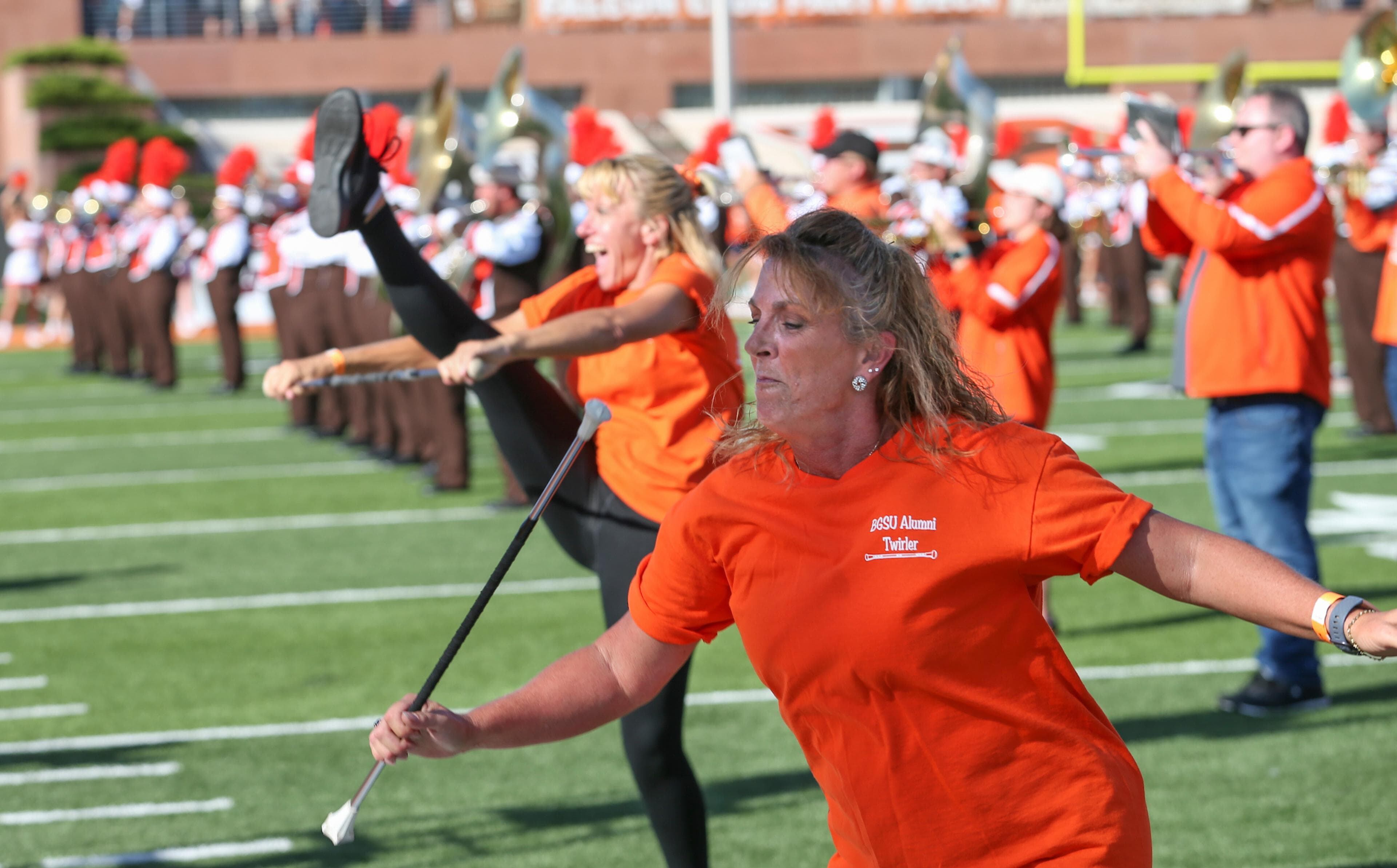 Two people twirl batons