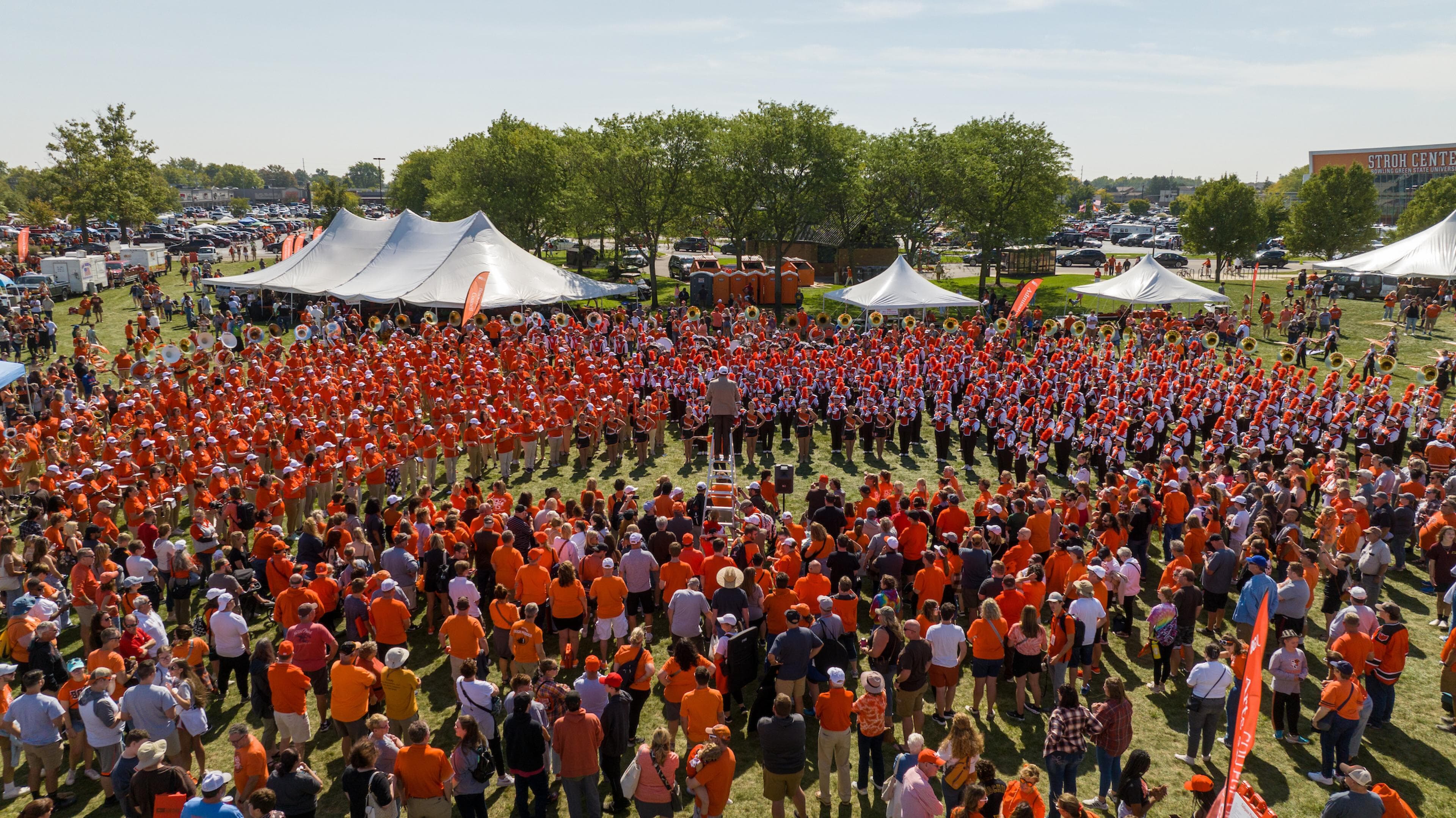 The alumni band performing with the Falcon Marching Band during Homecoming 2023