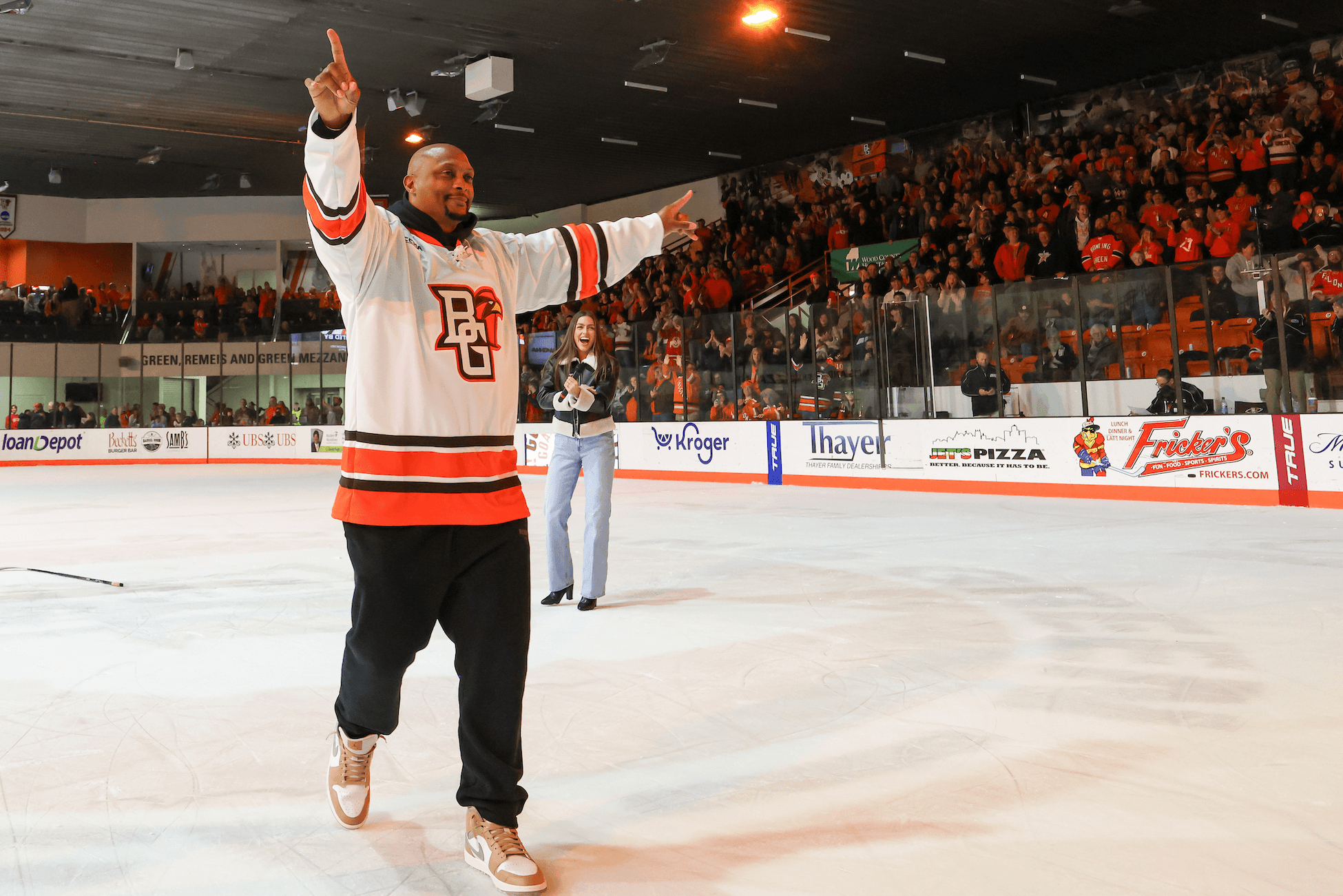 A person celebrates at center ice.