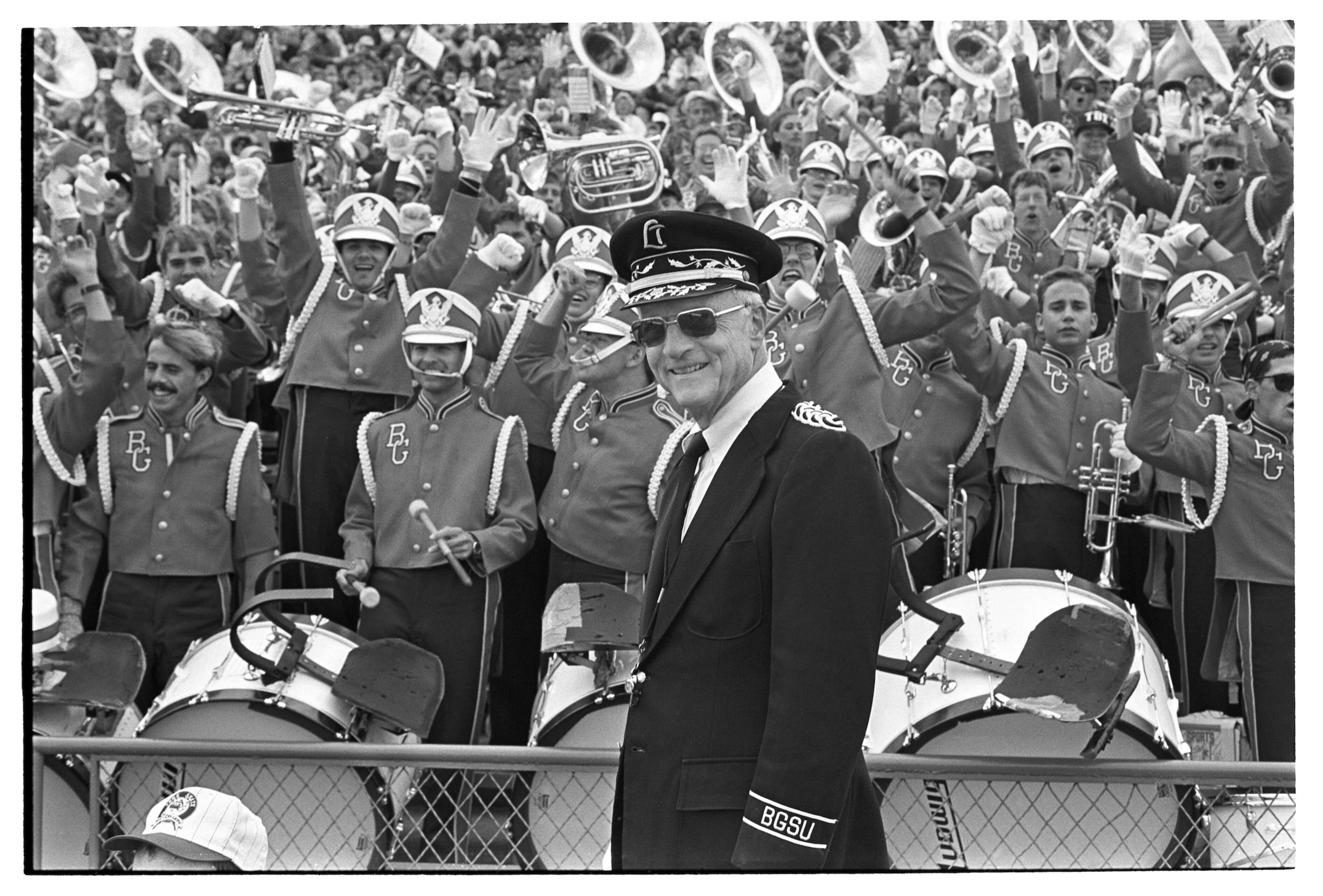 A black and white image of BGSU marching band and its director Mark Kelly