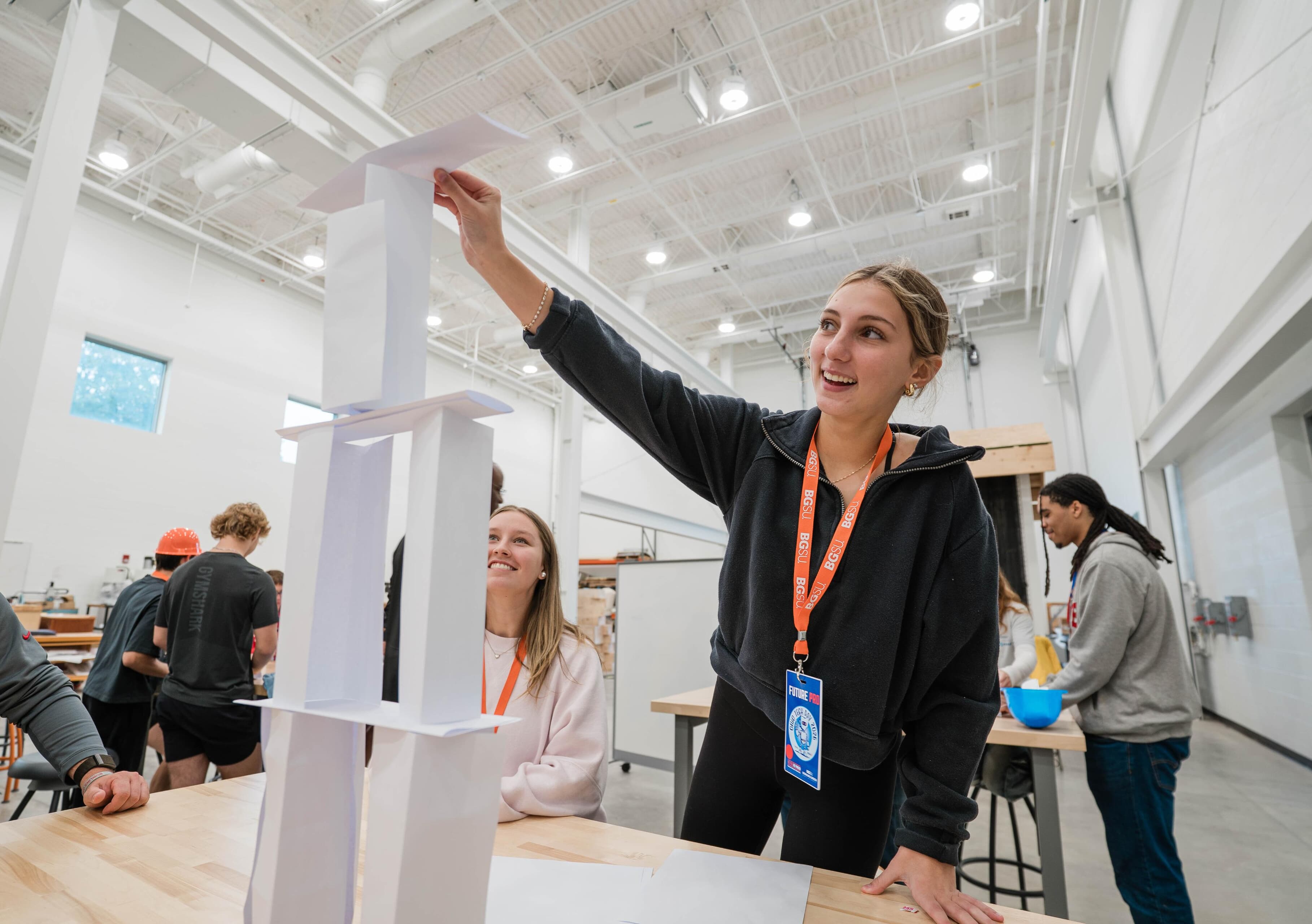 A student builds a tower with paper