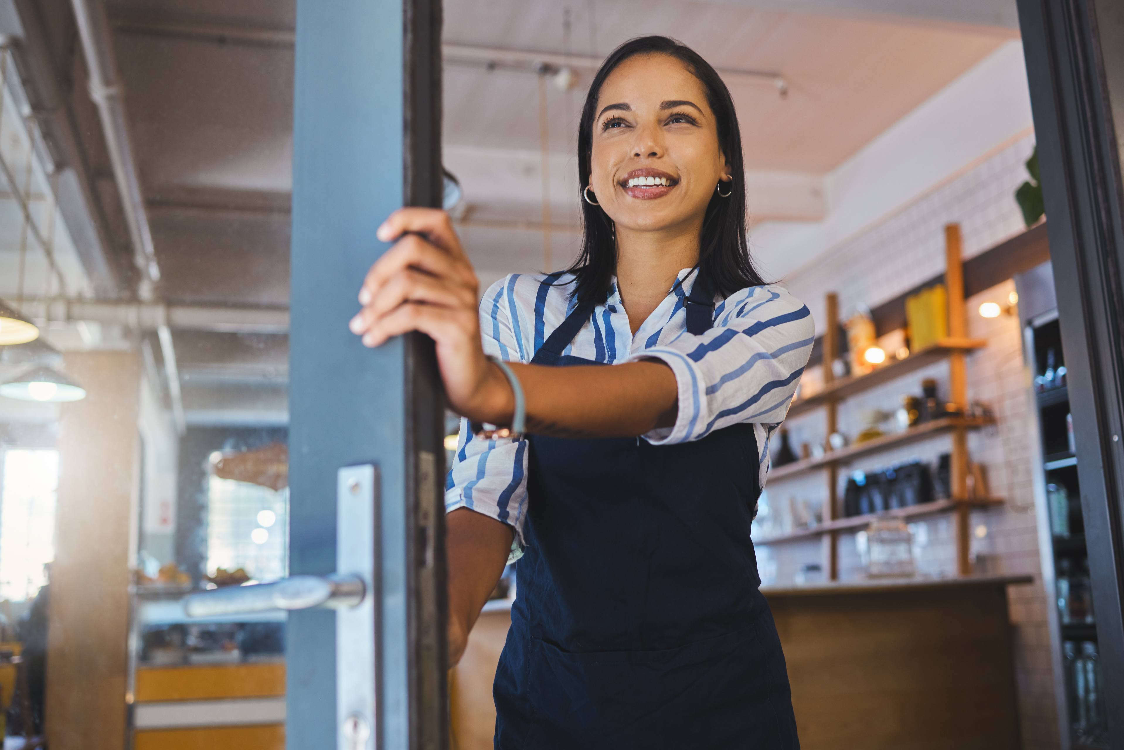 Welcome to opening cafe, entrance door and store of coffee shop, restaurant or small business. Happy manager, proud entrepreneur and hospitality worker ready for good waitress service in open startup