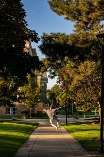 A student jumping outside